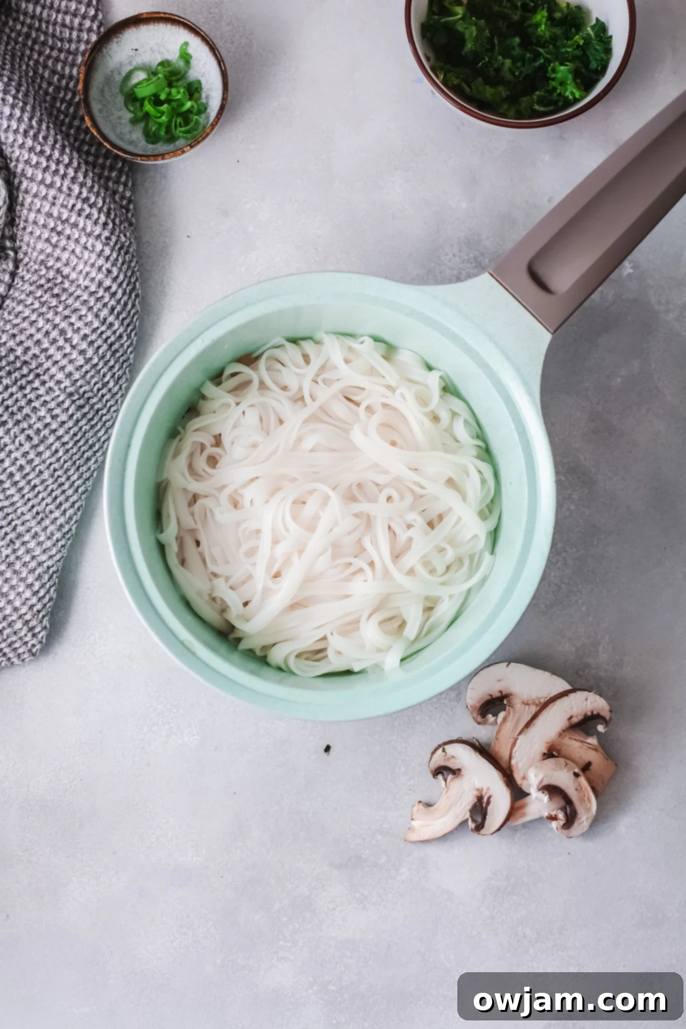 Delicious Korean Noodles in Minutes 4 Ingredients for Easy Korean Noodles Recipe laid out on a cutting board.