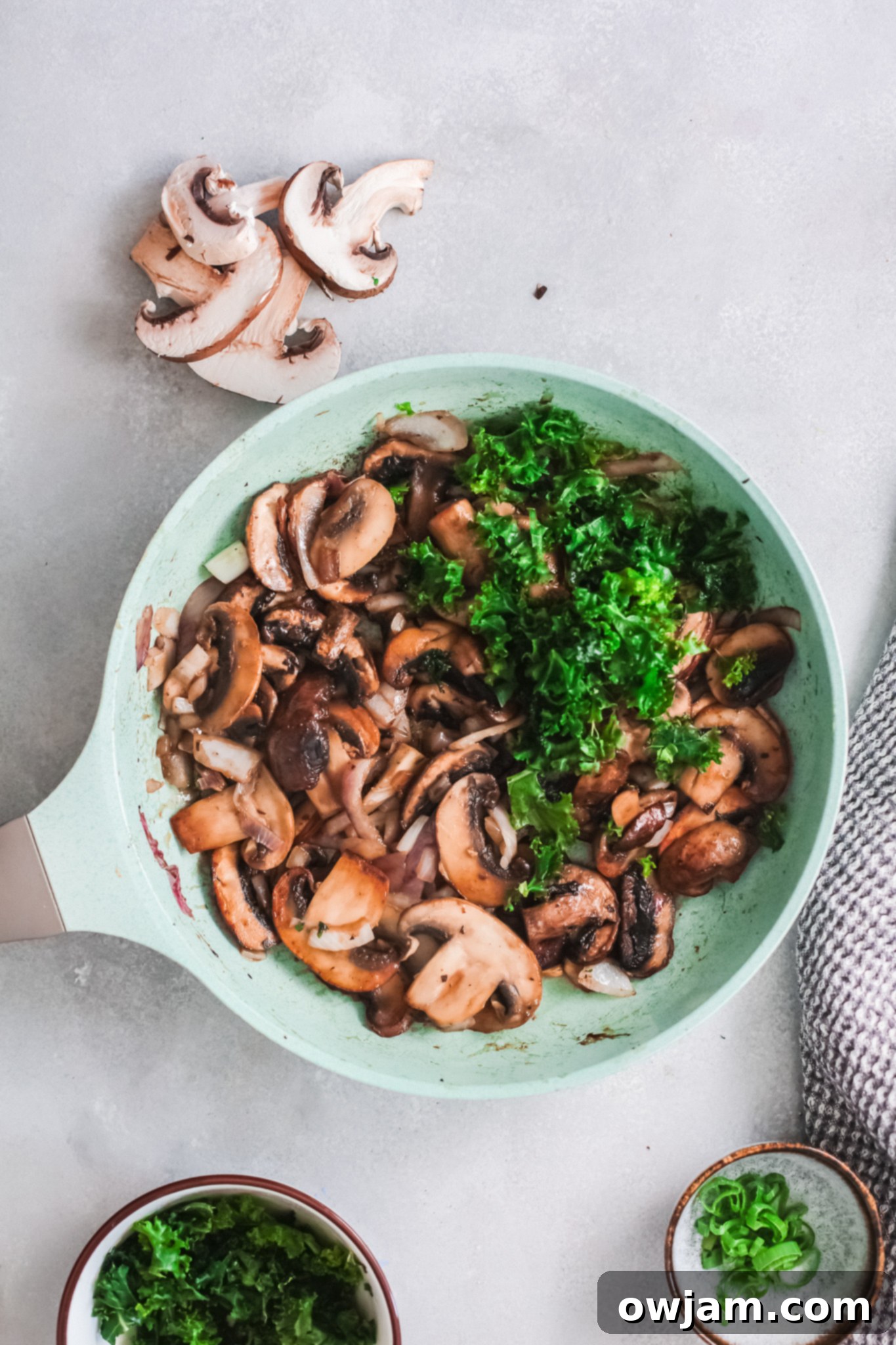 Delicious Korean Noodles in Minutes 9 Wilted kale in a skillet with other vegetables for Korean Noodles.