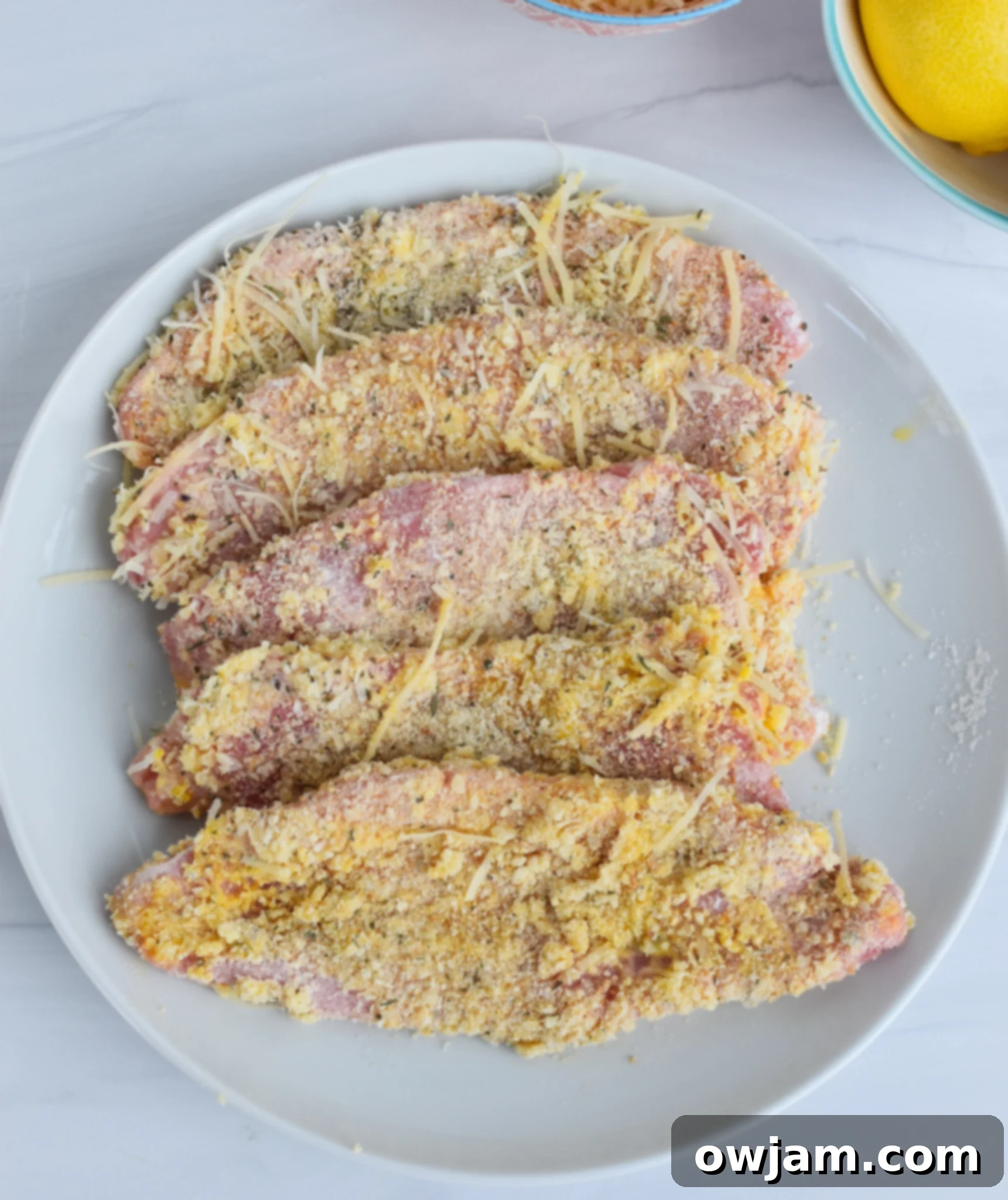 Effortless Homemade Veal Milanese 6 Easy Veal Milanese Recipe with freshly breaded cutlets waiting to be fried.