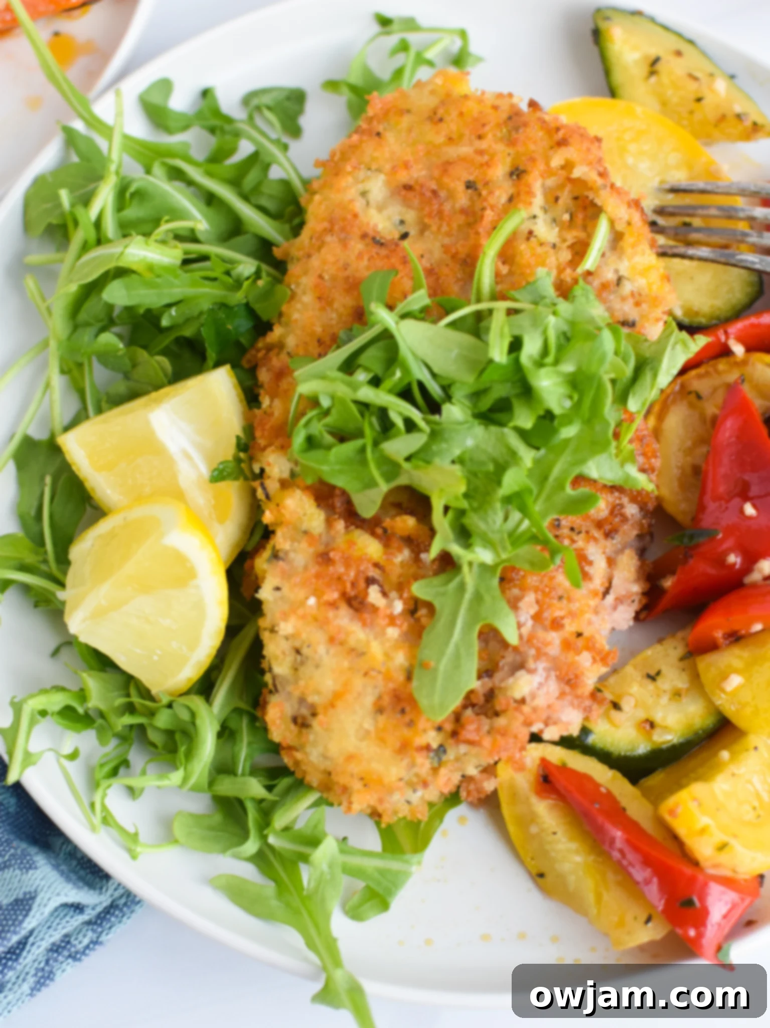 Effortless Homemade Veal Milanese 8 Plated Easy Veal Milanese Recipe with a side of fresh lemon wedges for garnish.