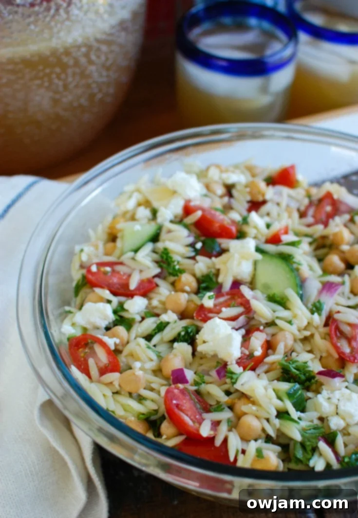 Refreshing Summer Orzo Pasta Salad with chickpeas, feta, and crisp vegetables.