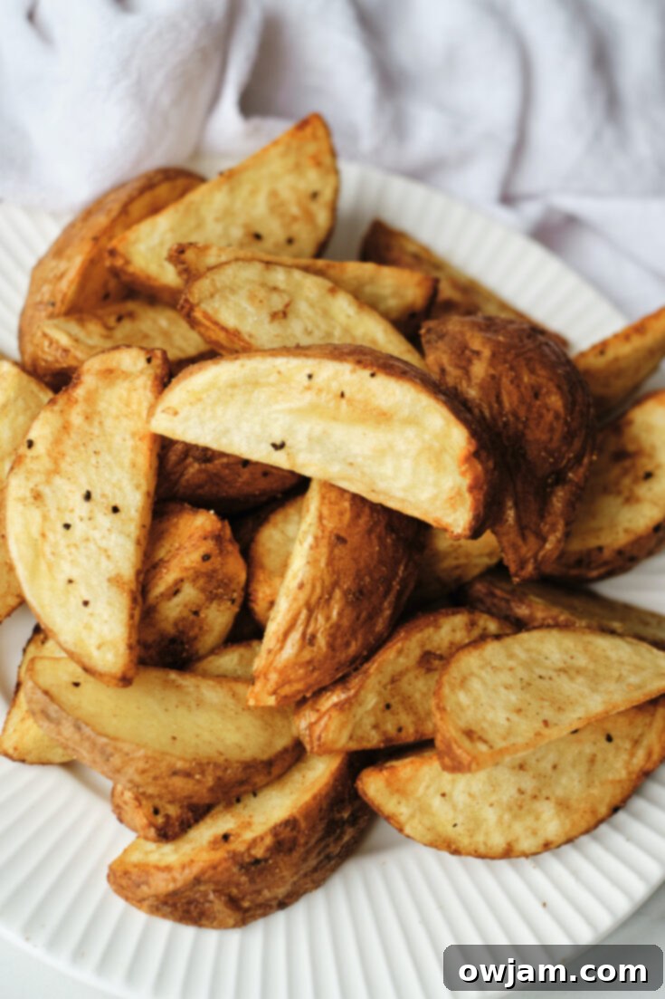 Golden and crunchy Air Fryer Potato Wedges, a versatile and easy side for steak.