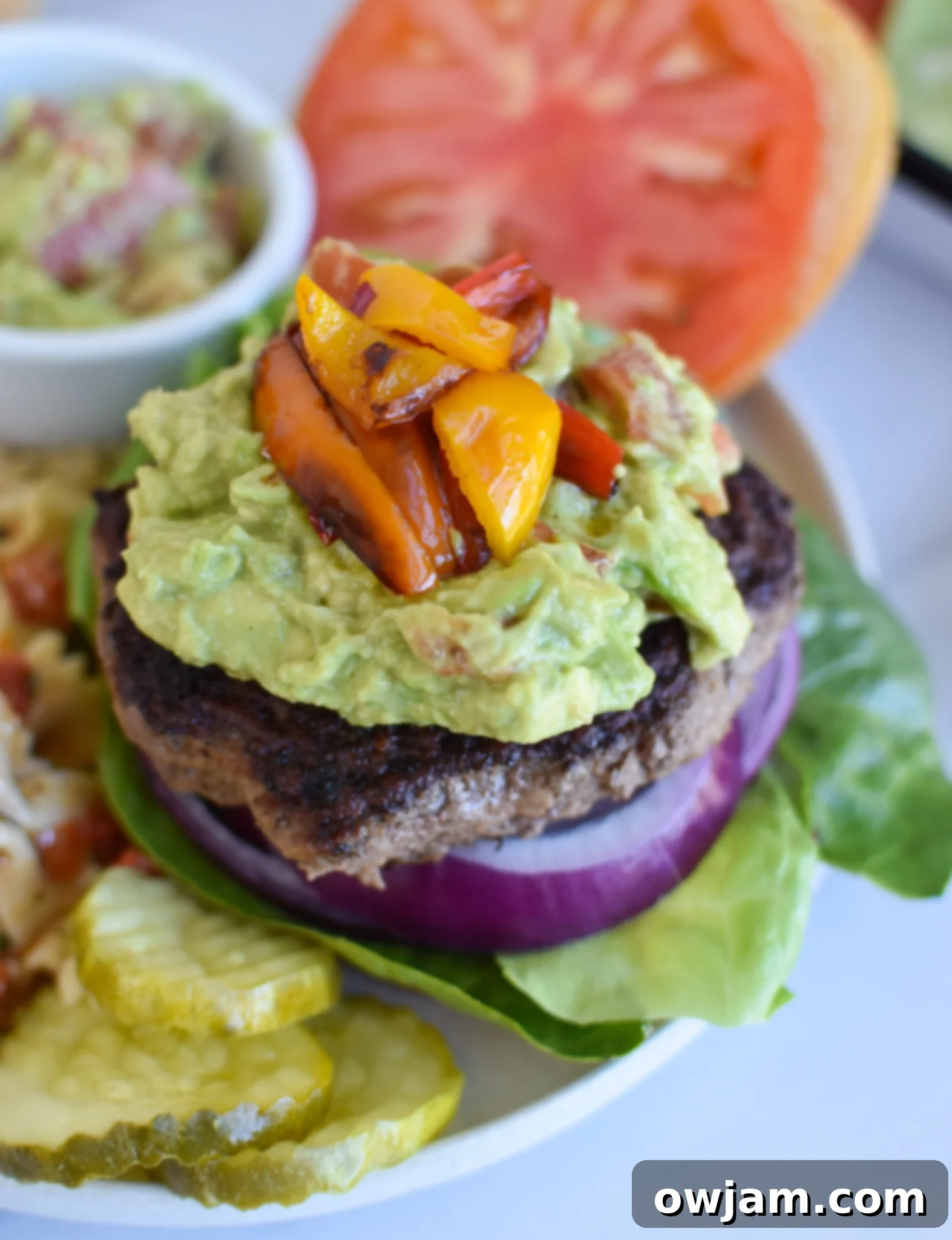 Fresh Avocado Burger 2 Easy Avocado Burger with creamy guacamole, red onion, tomato, lettuce, and grilled sweet peppers.