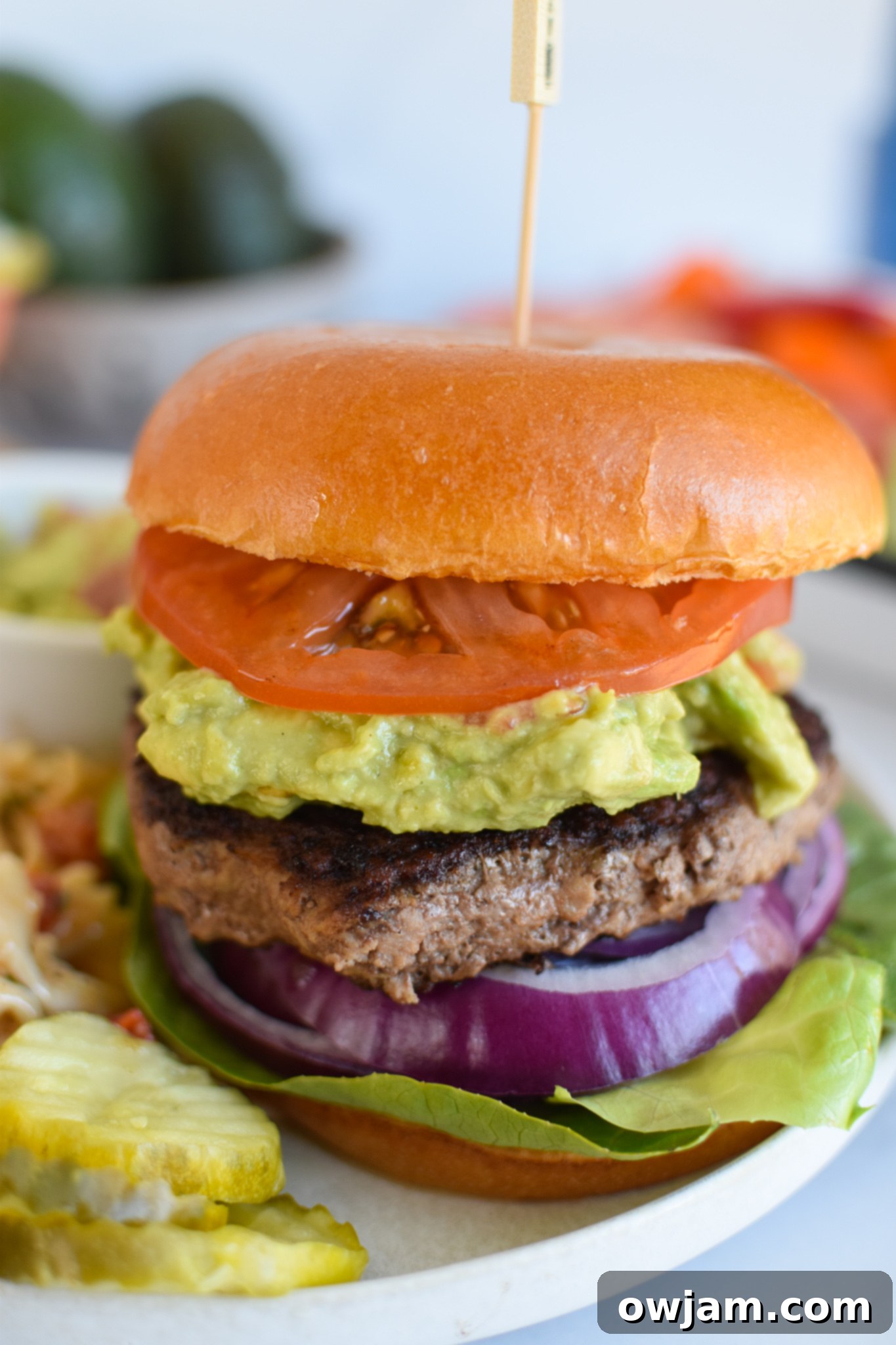 Fresh Avocado Burger 4 Easy Avocado Burger served on a bun with generous guacamole, lettuce, and tomato.