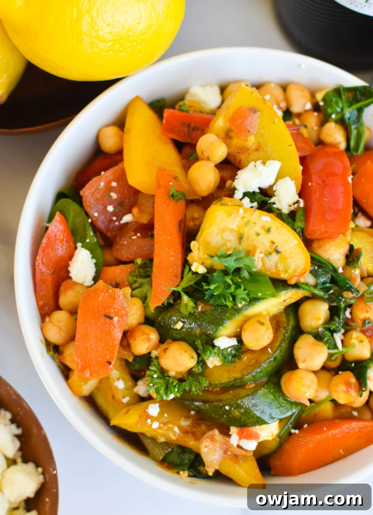 Vibrant Mediterranean Chickpea Skillet 4 A serving of Mediterranean Chickpea Skillet in a bowl, garnished with fresh herbs and feta.