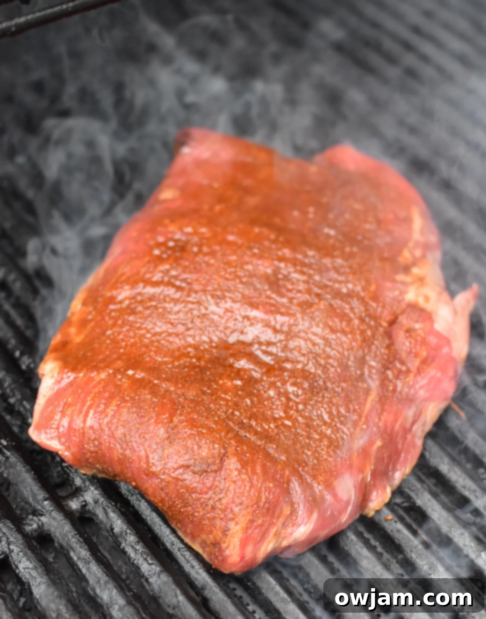Grilled Flank Steak with Dry Rub on grill. 
