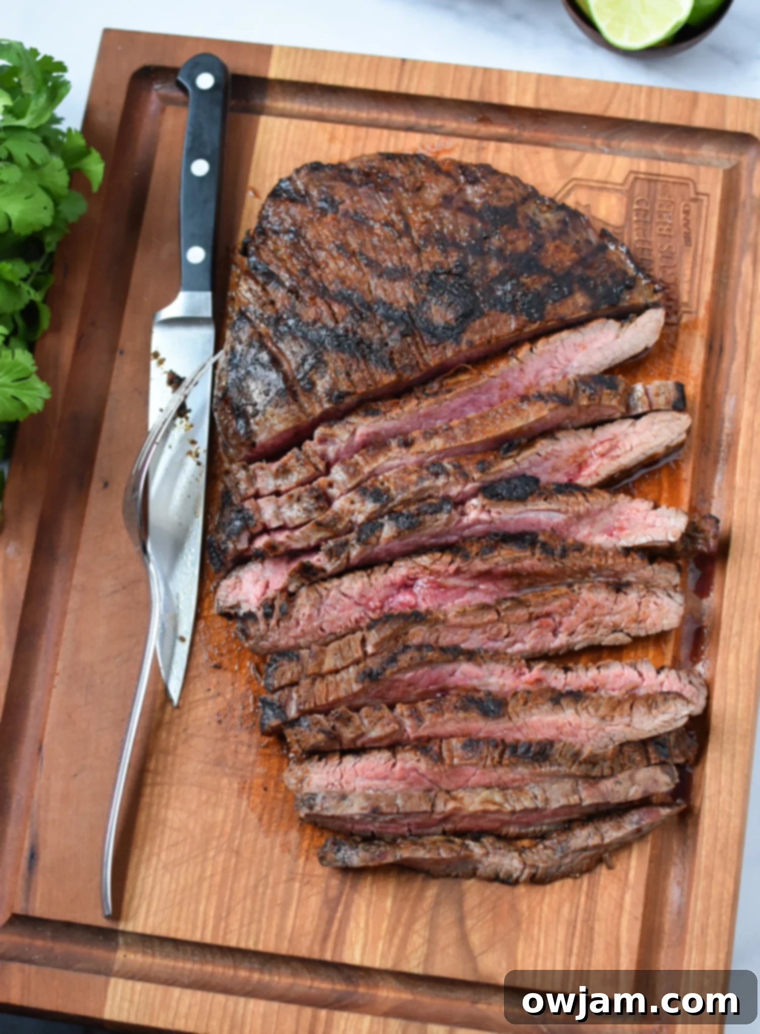 Grilled Flank Steak with Dry Rub on cutting board. 
