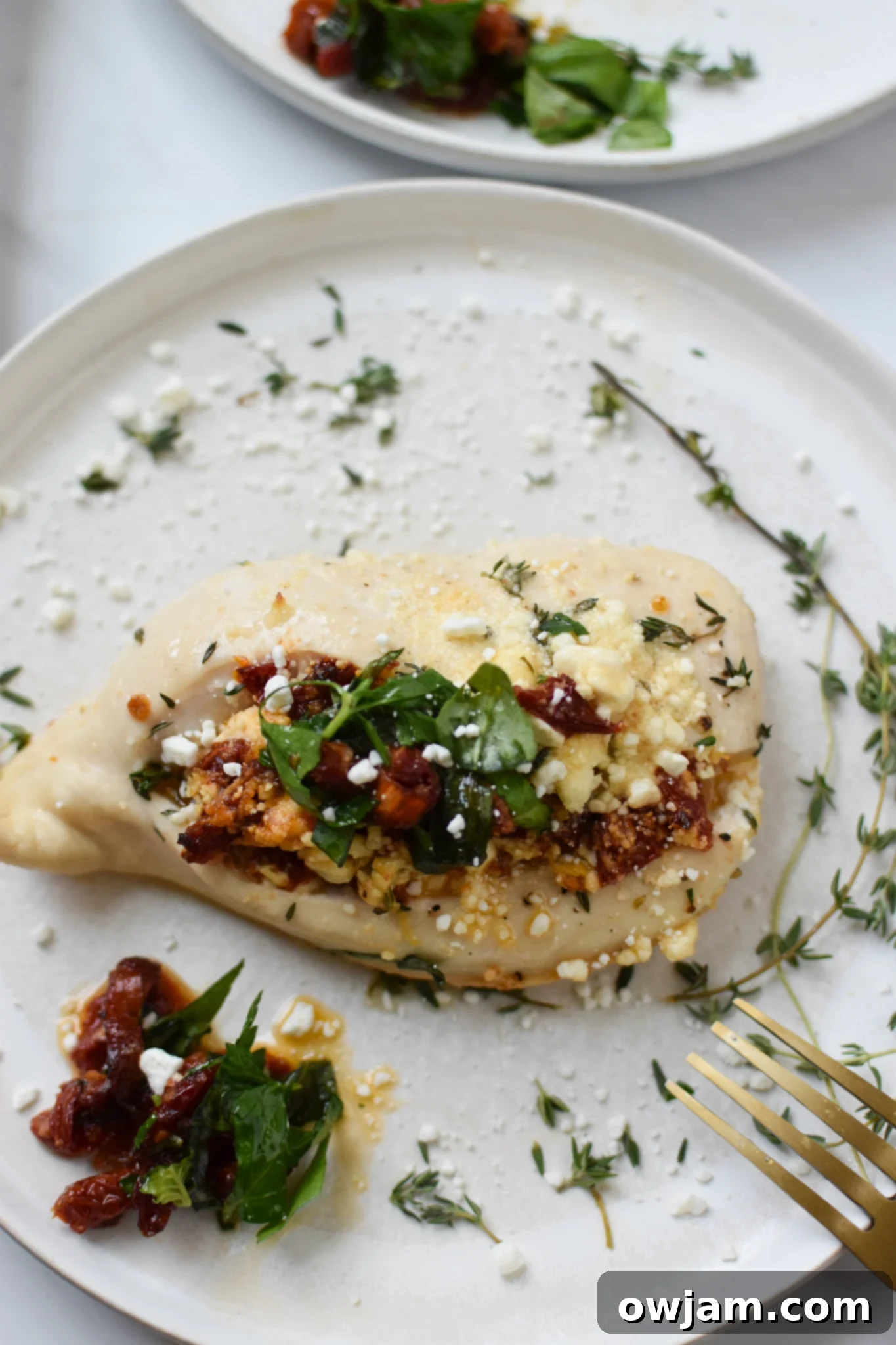 Tangy Sun-dried Tomato and Goat Cheese Stuffed Chicken 8 Close-up of Sun-dried Tomato Goat Cheese Stuffed Chicken Breasts garnished with thyme.