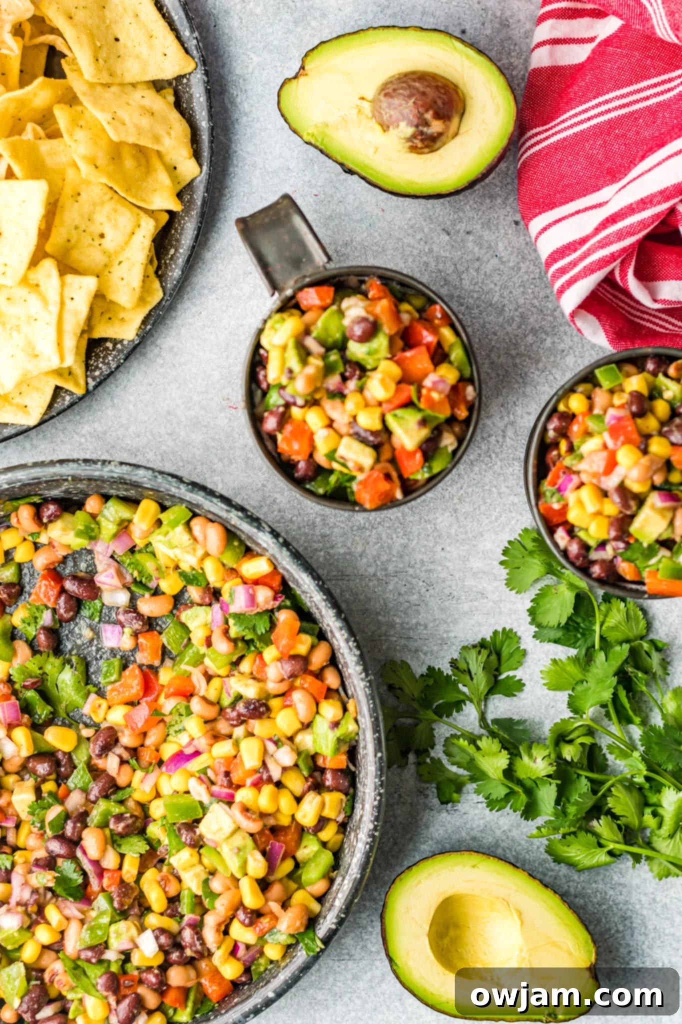 Freshly made Cowboy Caviar Recipe in a rustic tin bowl, garnished with cilantro.