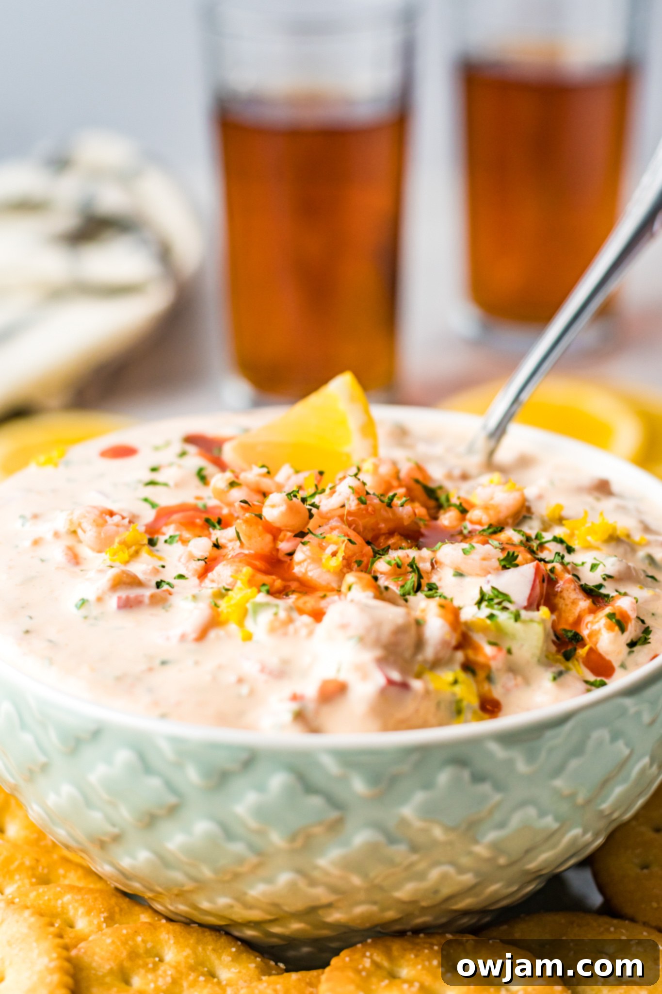 Irresistible Shrimp Dip 2 Shrimp Dip Recipe in light blue bowl with spoon, ready to serve.