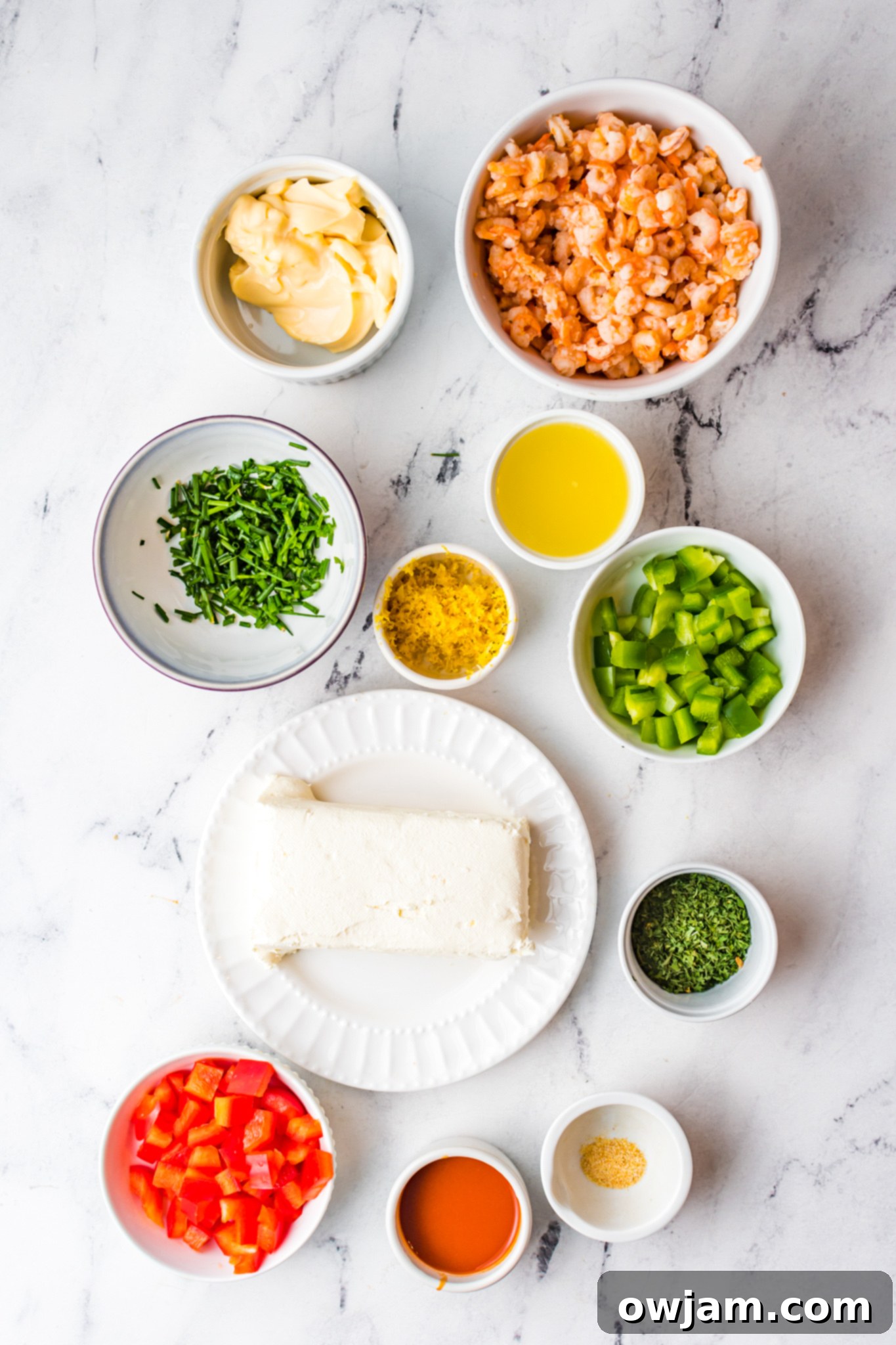 Irresistible Shrimp Dip 3 Ingredients laid out for Shrimp Dip Recipe preparation, including fresh herbs, hot sauce, and canned shrimp.