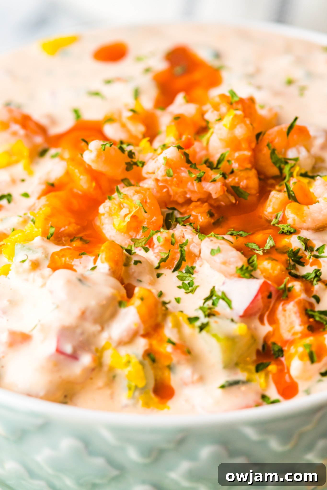 Irresistible Shrimp Dip 4 Shrimp Dip Recipe being mixed with hot sauce and other ingredients.