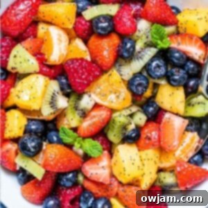 Fruit Salad with Lemon Poppy Seed Dressing, served in a white bowl.