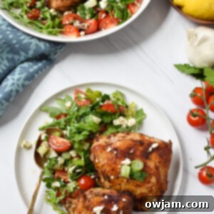 Crispy Air Fryer Mediterranean Chicken Thighs on a white plate with fresh herbs