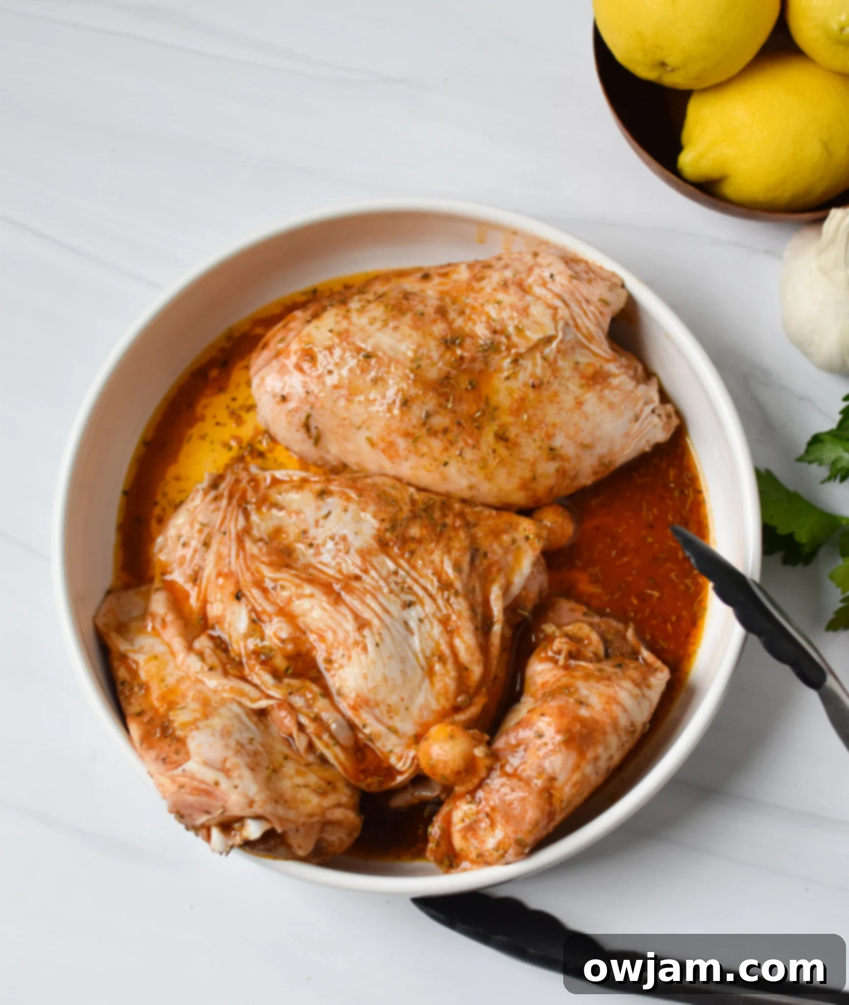 Air Fryer Mediterranean Chicken Thighs in a bowl ready to be air fried.