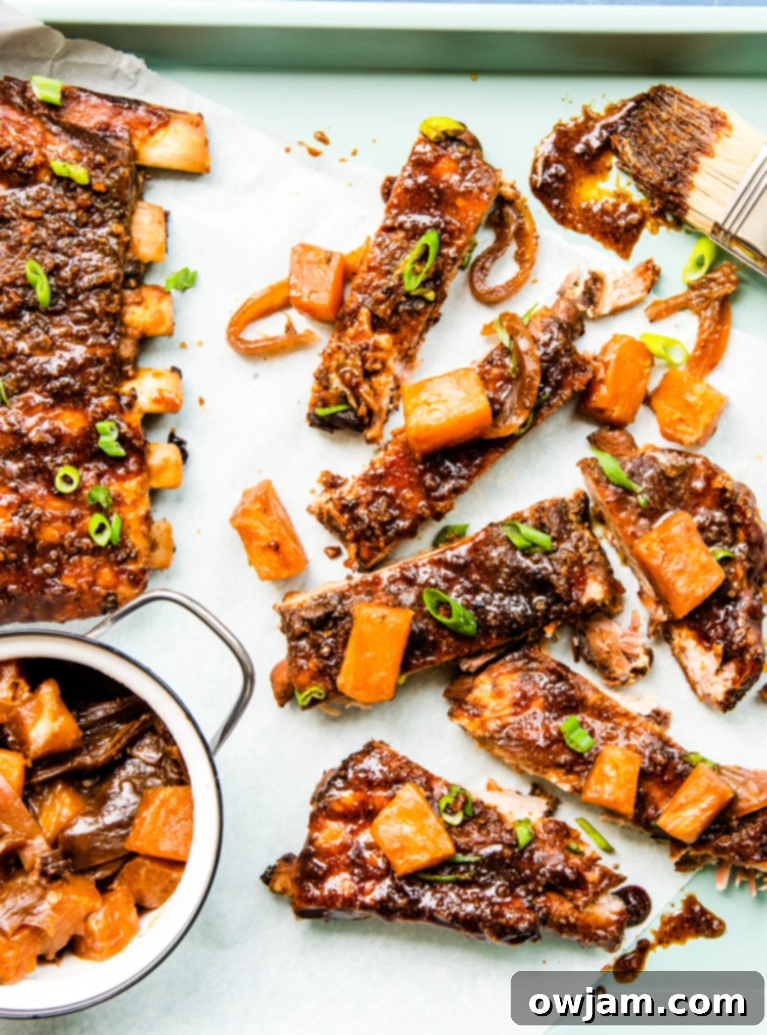 Aloha Slow Cooker Pork Ribs 4 Baby back ribs ready for preparation on a baking sheet.