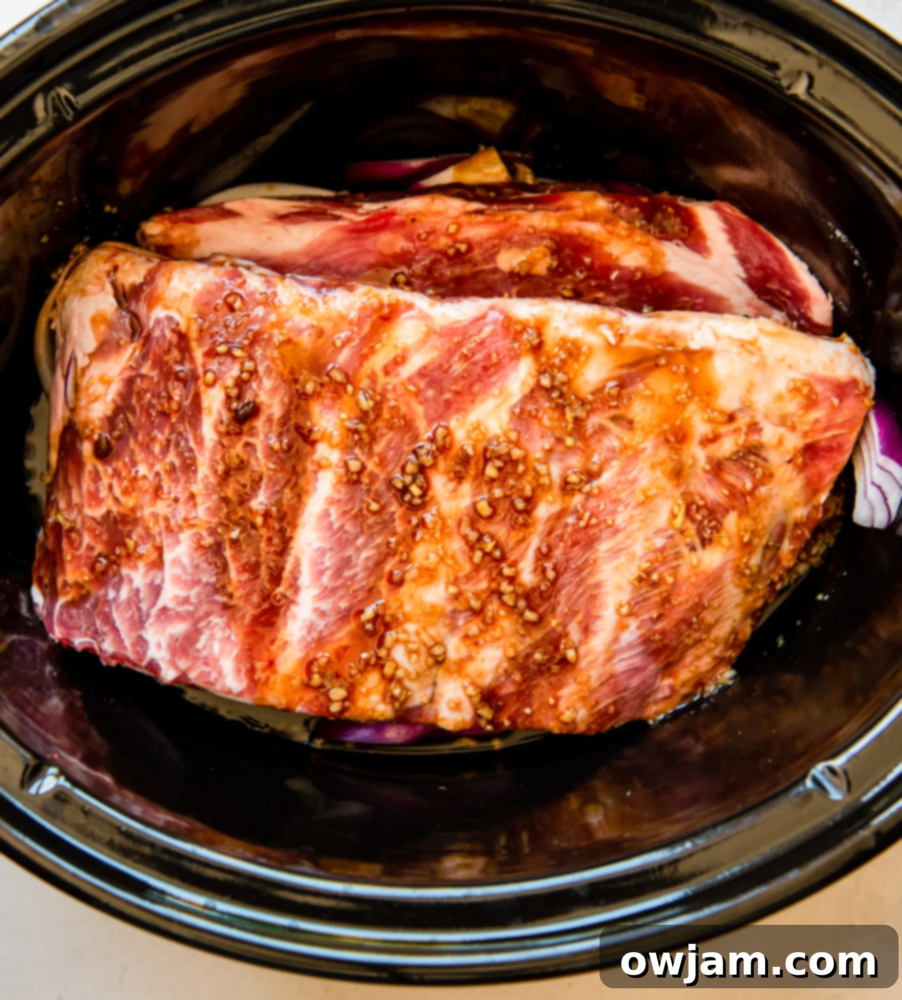 Aloha Slow Cooker Pork Ribs 7 Cooked Slow Cooker Hawaiian Pork Ribs with pineapple in the crockpot.