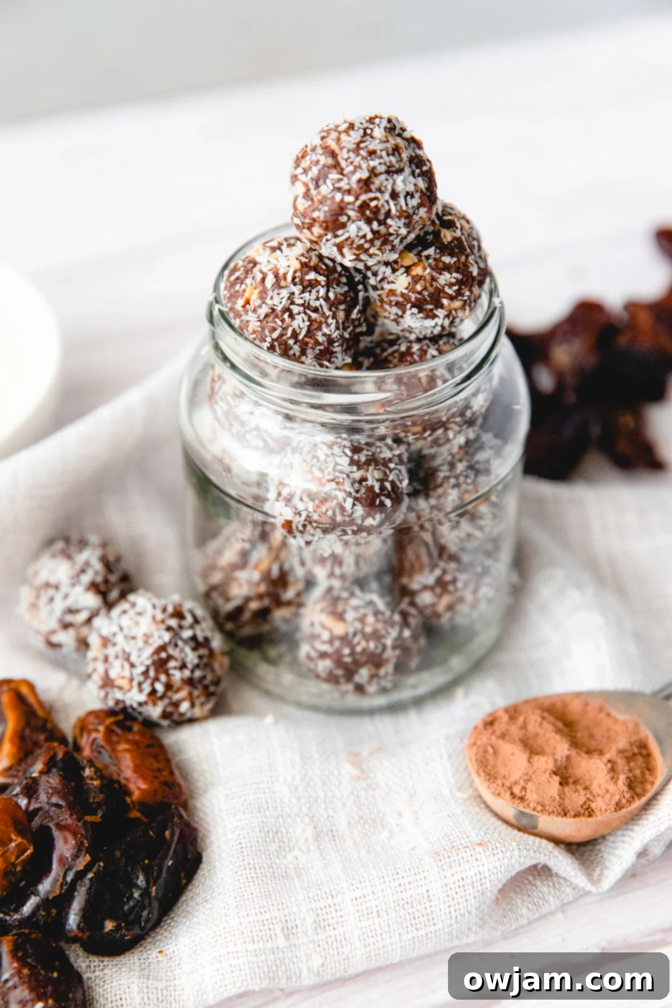 No-Bake Date Energy Bites 2 Easy Date Protein Balls in a jar, ready to be enjoyed as a healthy snack.