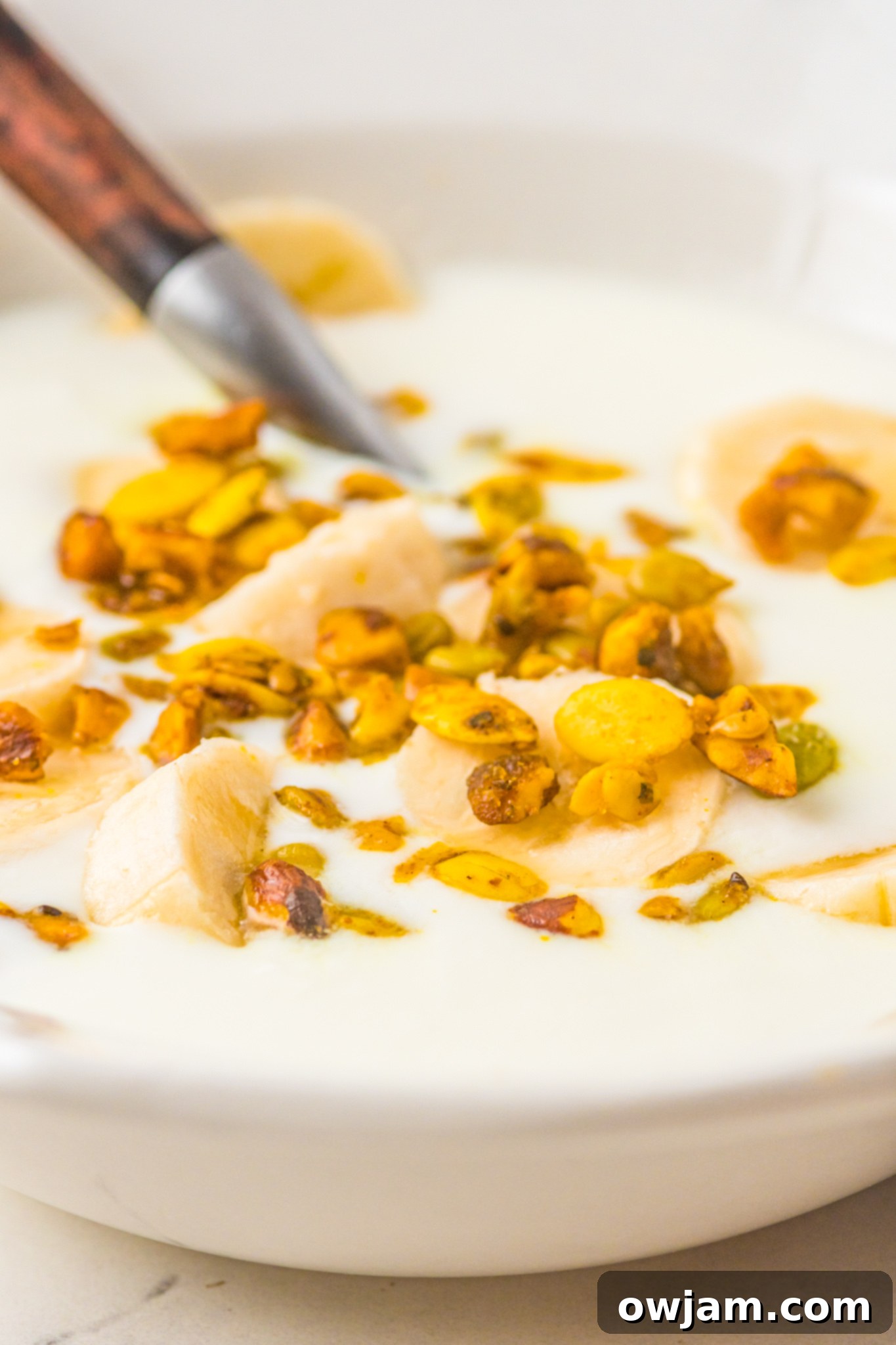 Easy Instant Pot Yogurt 7 A bowl of Instant Pot yogurt topped with crunchy granola, ready for a healthy breakfast or snack.