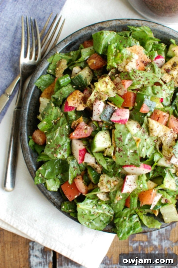 Savory Turkey Kofta Kebab 3 Fattoush Salad with silverware, a perfect accompaniment to kofta kebabs.