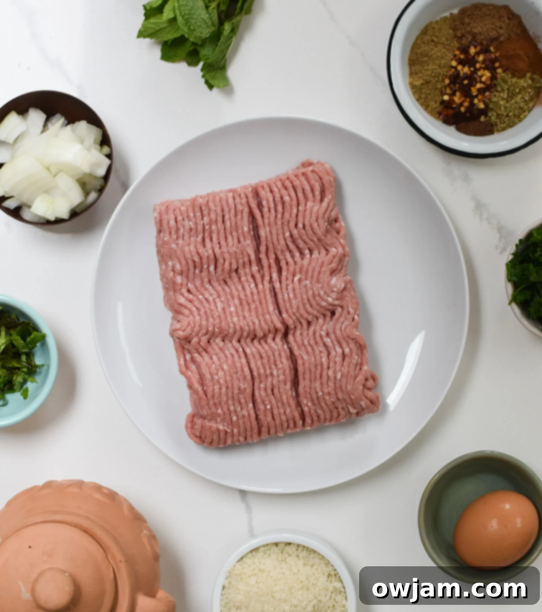 Savory Turkey Kofta Kebab 6 Ingredients for Turkey Kofta Kebab Recipe laid out on a table, including spices, herbs, and ground turkey.
