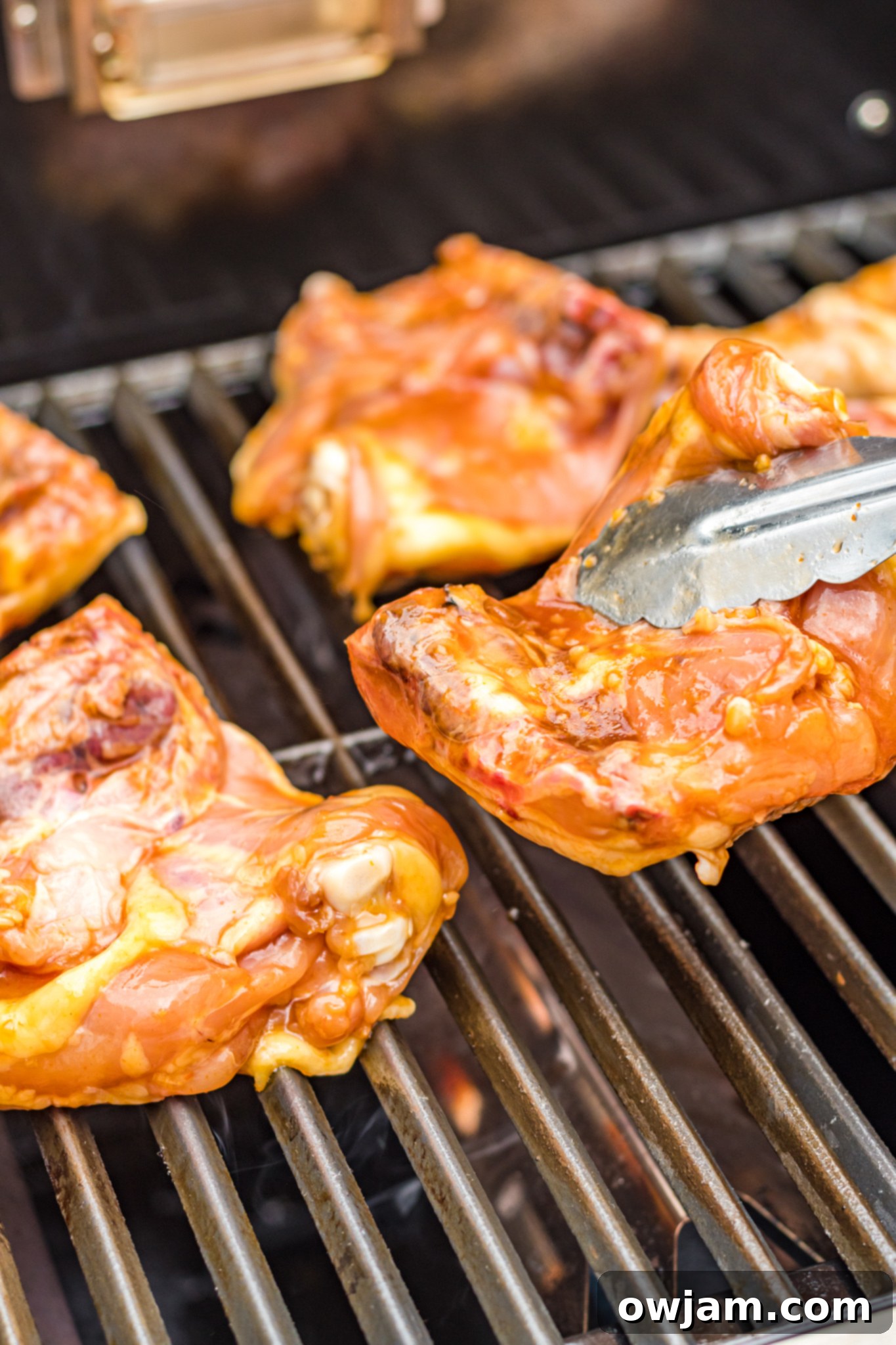 Hawaiian Fire Chicken 8 Huli Huli Chicken cooking on a hot grill, showing the beginning of grill marks and caramelization.