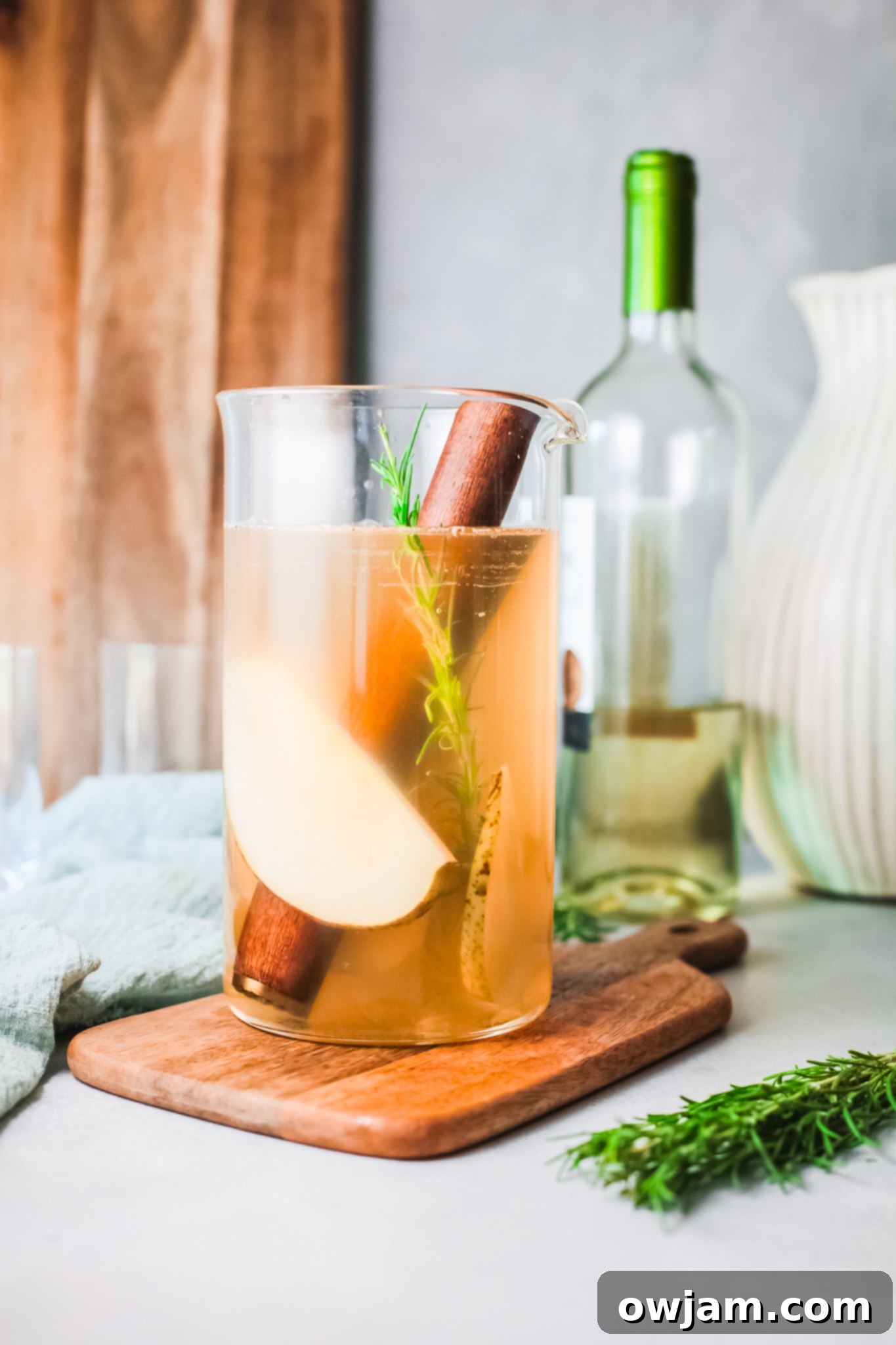 White Sangria Recipe pouring wine into pitcher. 
