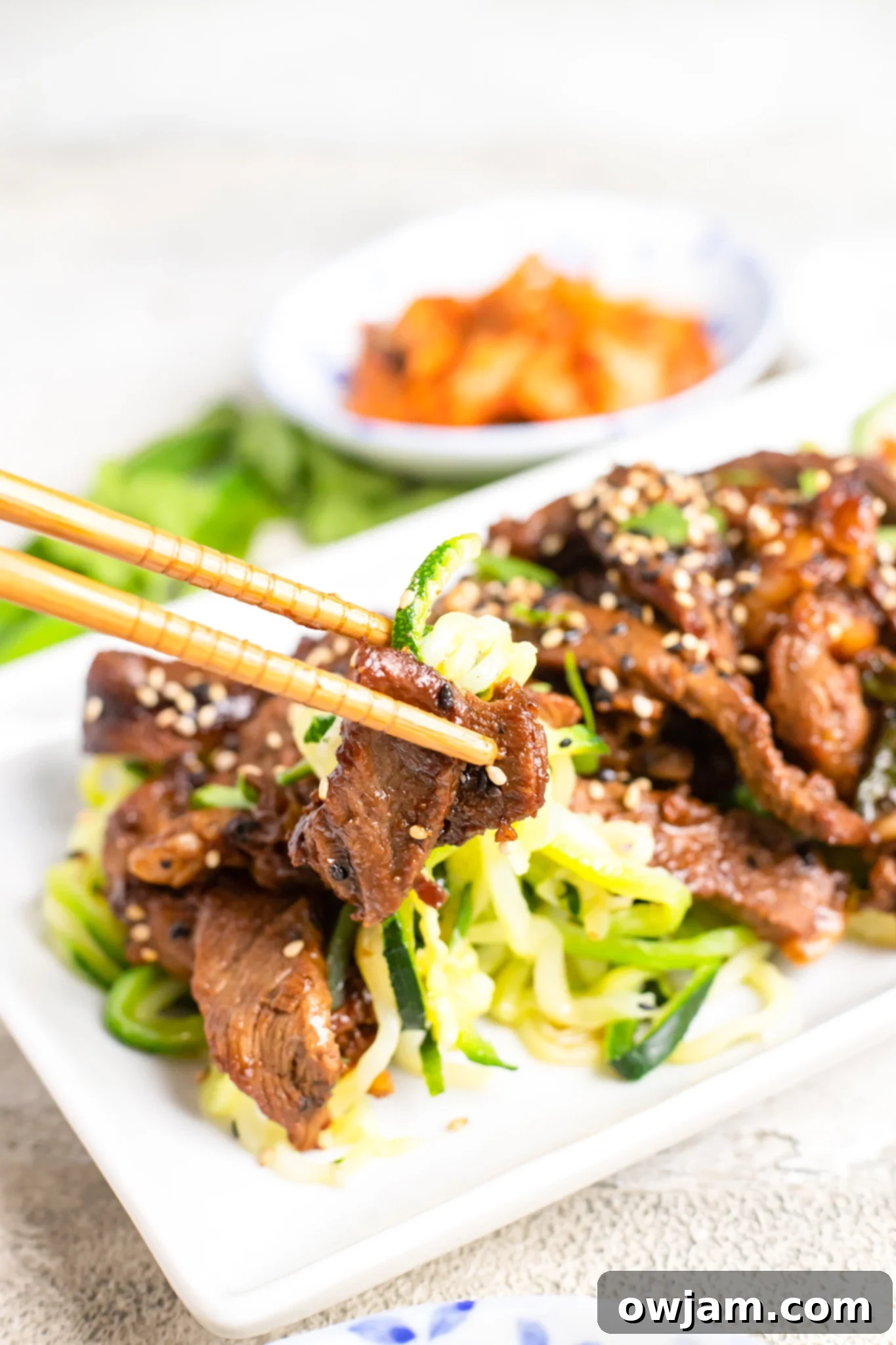 Bulgogi Zoodle Bowl 11 Beef Bulgogi with Zucchini Noodles with chopsticks.