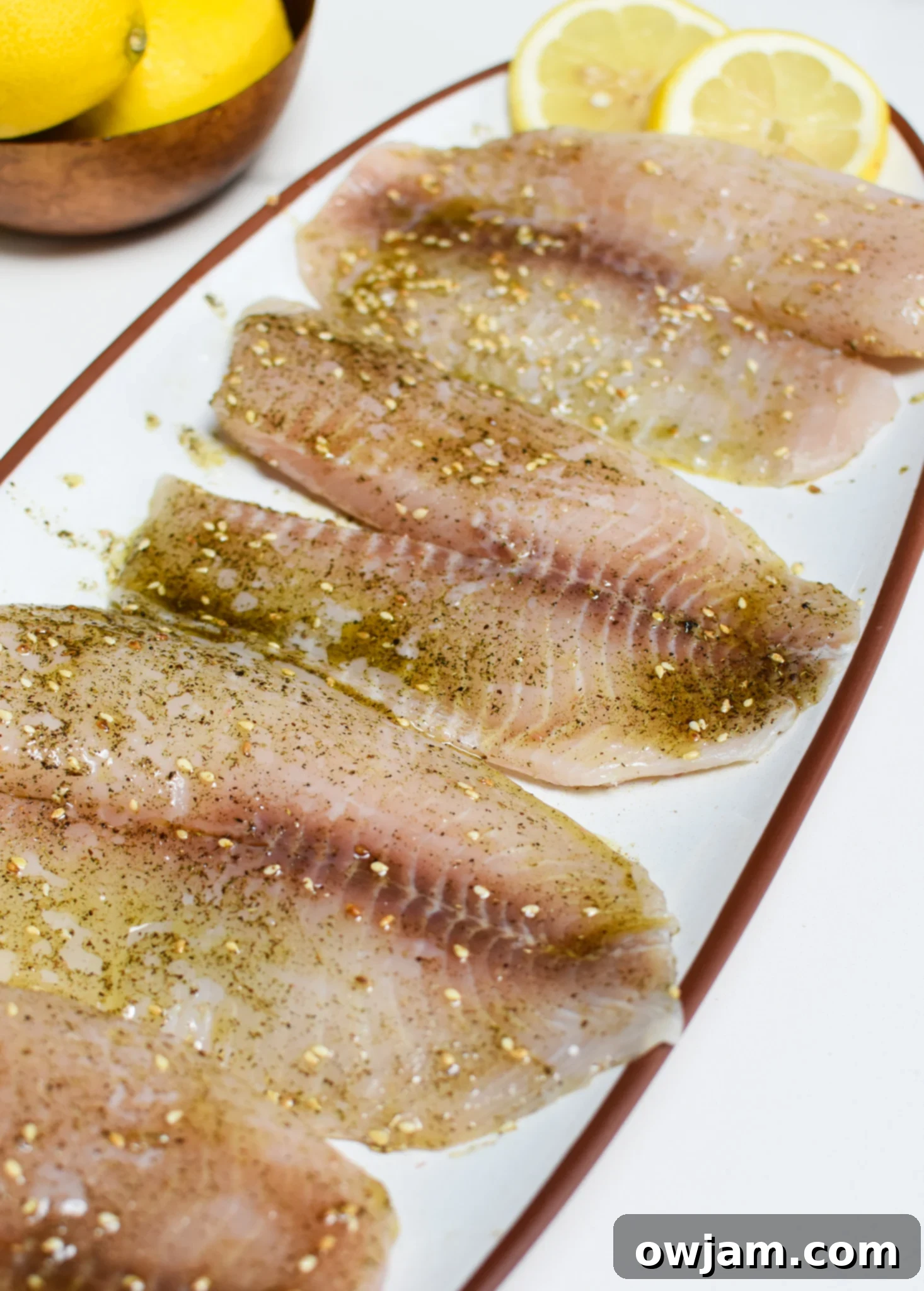 Golden Mediterranean Tilapia Bake 4 A beautifully arranged platter of Mediterranean Baked Tilapia with roasted vegetables and lemon slices, ready to be served.