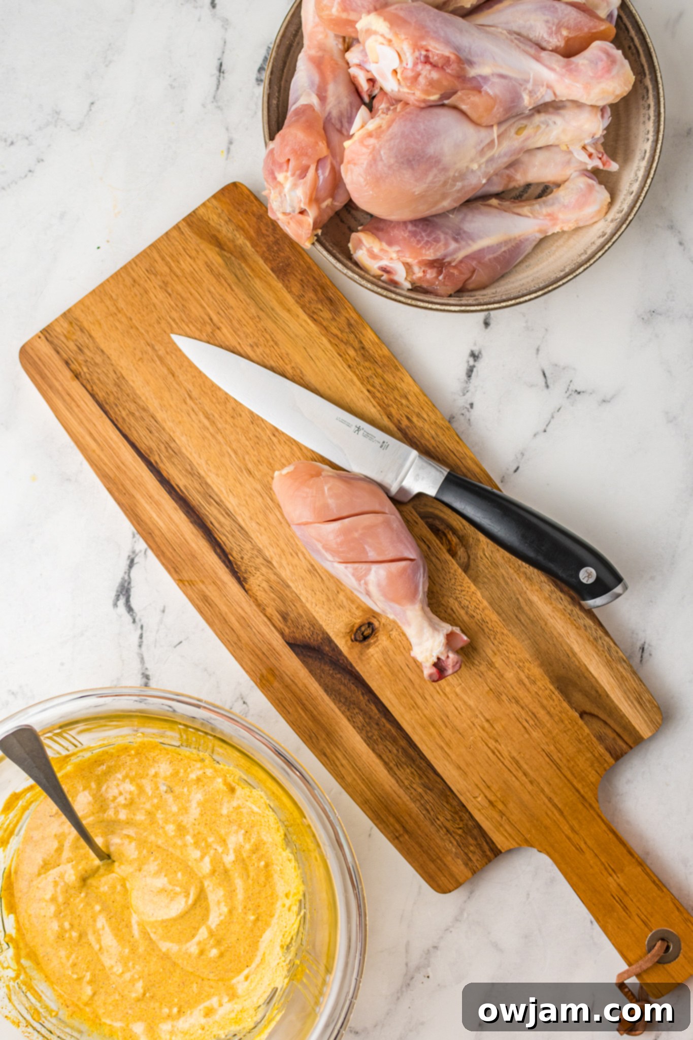 Air Fryer Tandoori Chicken Legs on cutting board, scored.