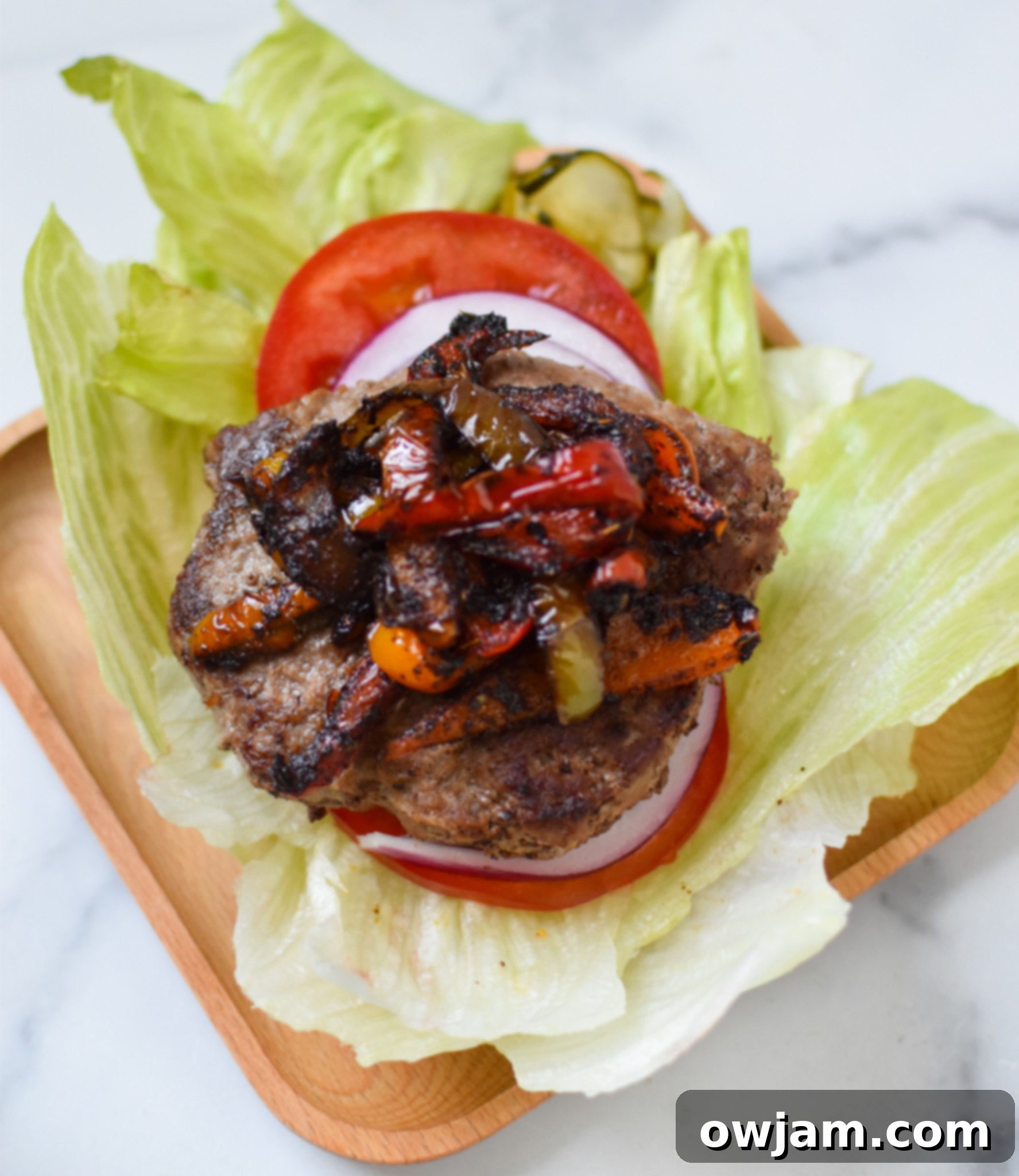 A beautifully presented Fajita Lettuce Burger on a plate, highlighting the fresh lettuce wrap and colorful fajita toppings.
