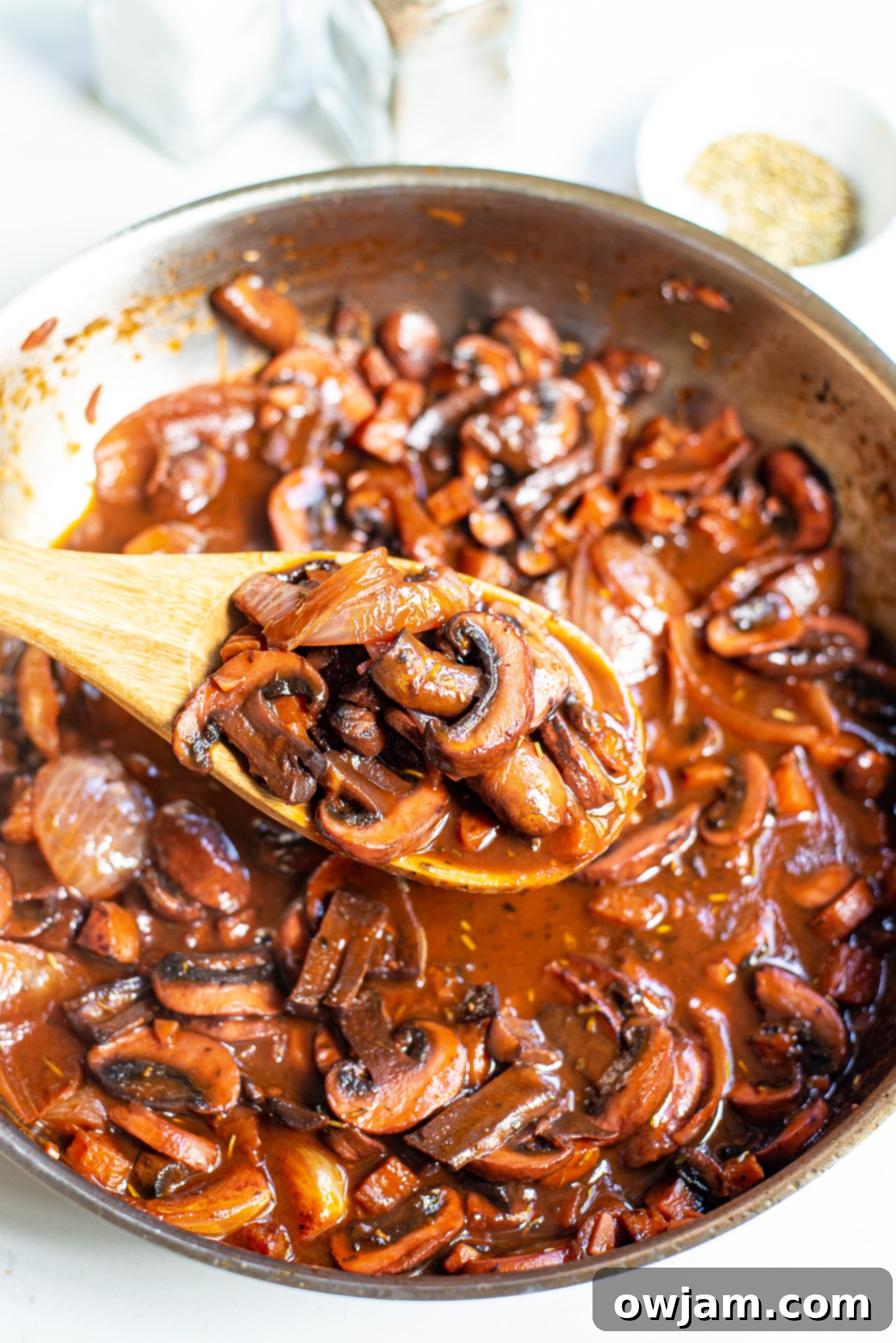 Mushroom Bourguignon simmering in a cast iron pan.