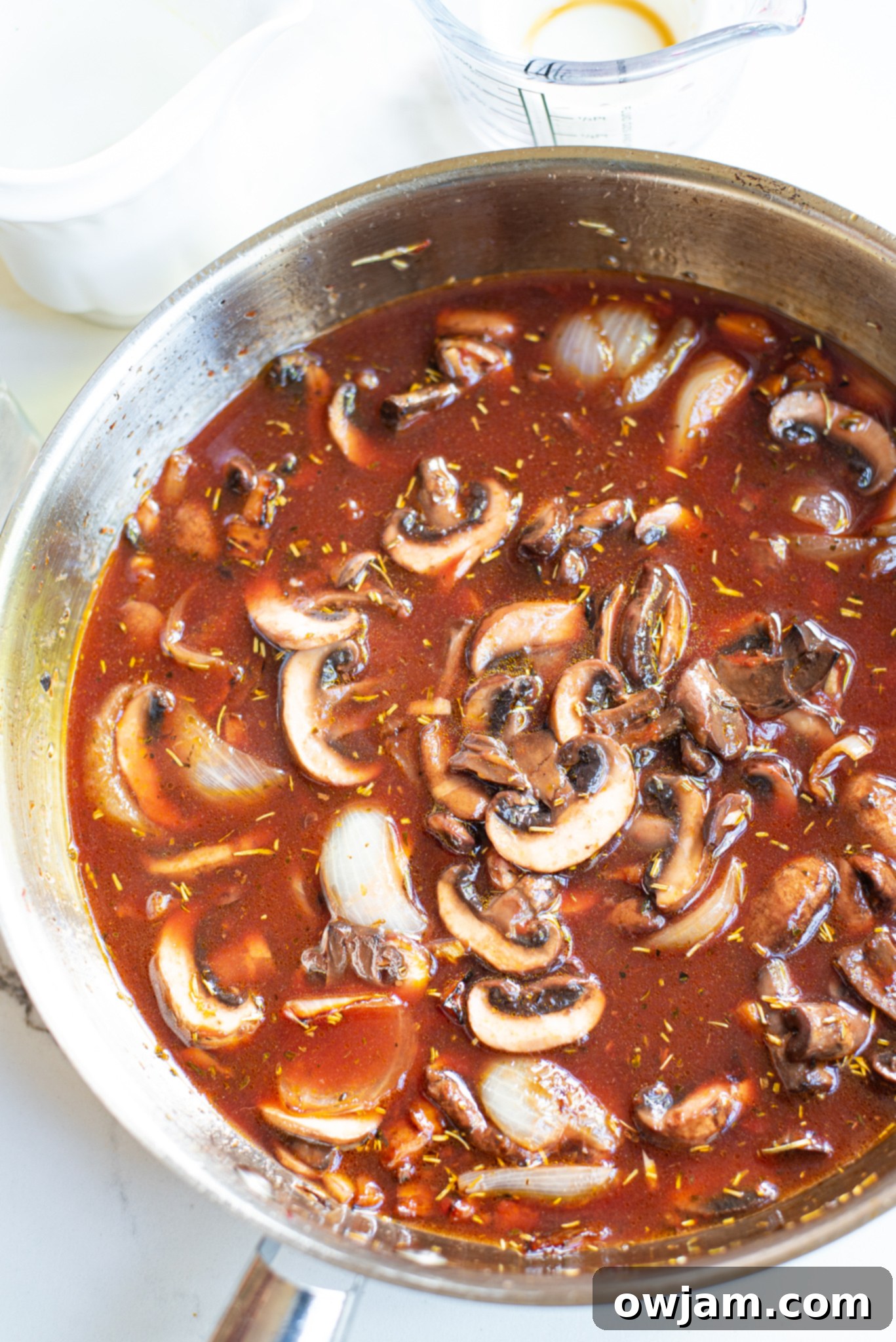 Close-up of tender Mushroom Bourguignon in a pan, ready to serve.