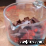Coarsely chopped dark chocolate pieces in a bowl, ready for melting to create the base layer of peppermint bark.