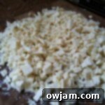 White chocolate chunks in a bowl, prepared for melting to form the second layer of this festive peppermint bark.