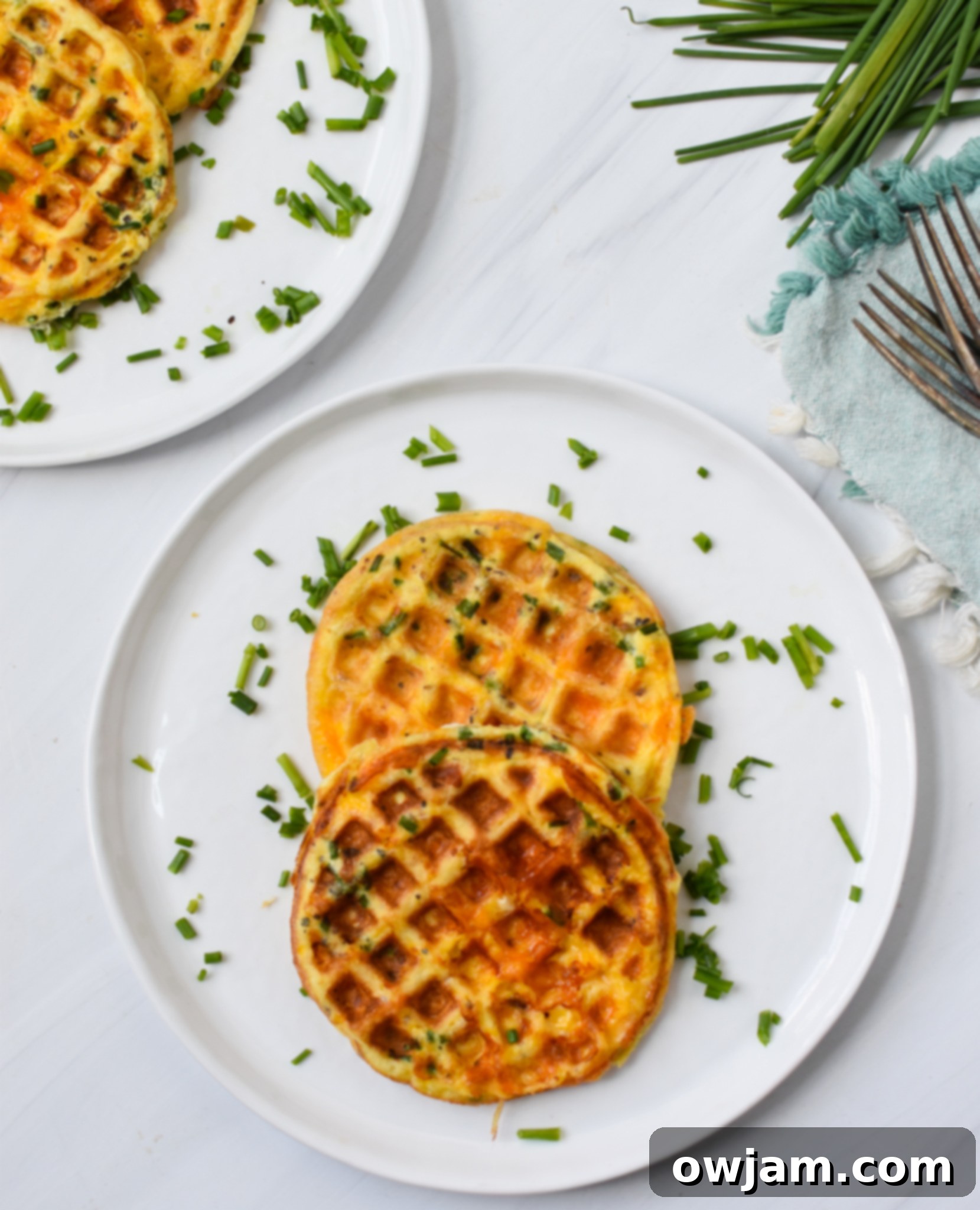 Chaffles Recipe batter with herbs being mixed in a bowl.