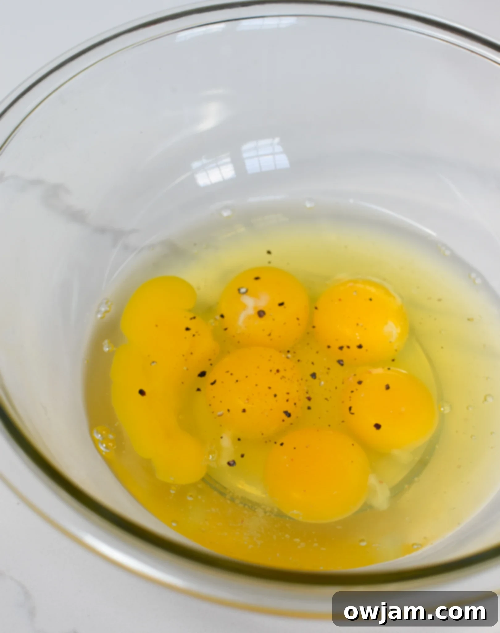 Whisked eggs in a medium mixing bowl, ready for additional ingredients for the Chaffles Recipe.