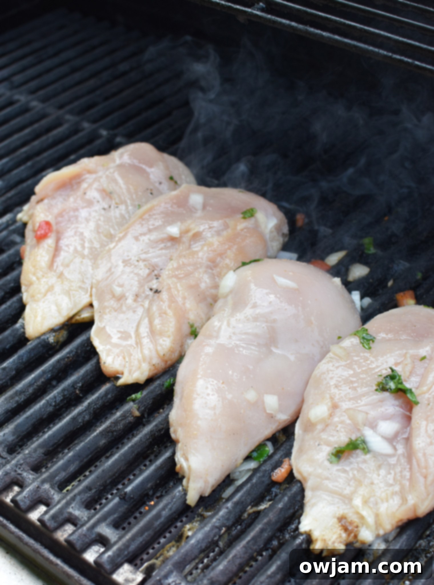 Margarita Marinated Grilled Chicken 5 Margarita Grilled Chicken cooking on the grill, showing appetizing char marks and vibrant colors, ready to be flipped.
