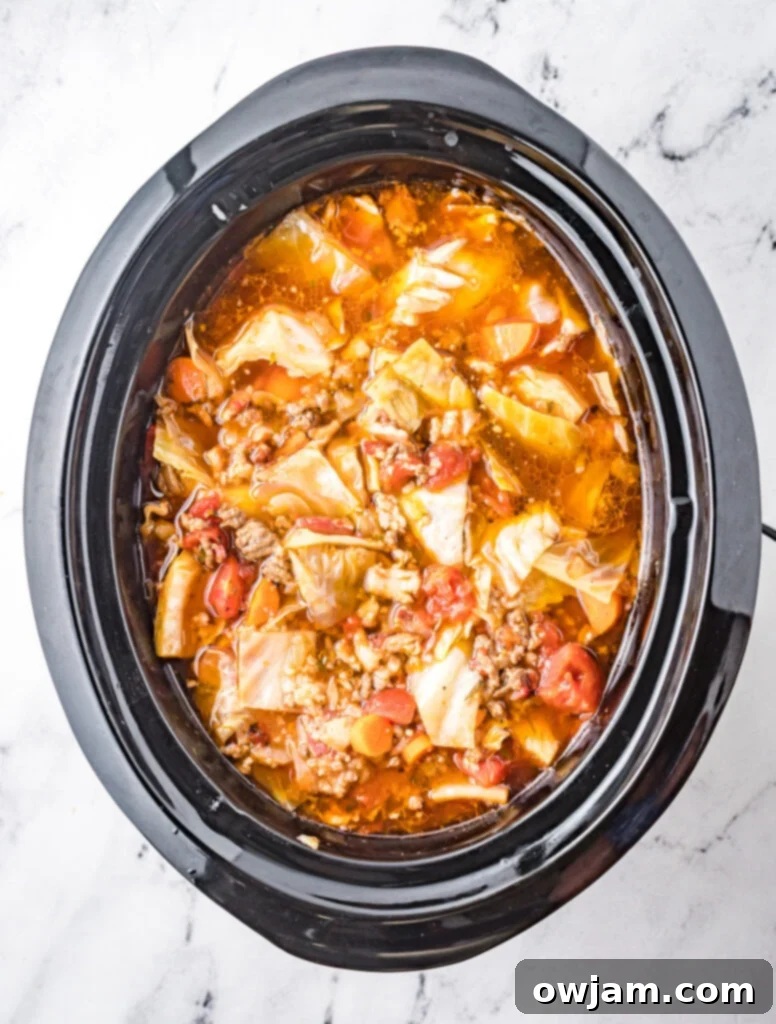 Deconstructed Cabbage Roll Soup 6 Cooked Cabbage Roll Soup simmering in a slow cooker.