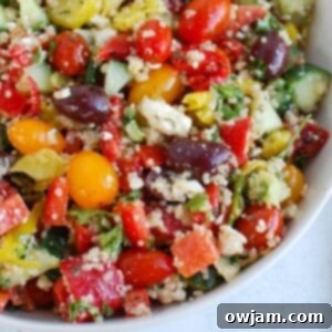 Vibrant Mediterranean Quinoa Salad 7 A beautifully presented Greek Quinoa Salad, vibrant with fresh ingredients, in a bowl, captured from an overhead perspective.