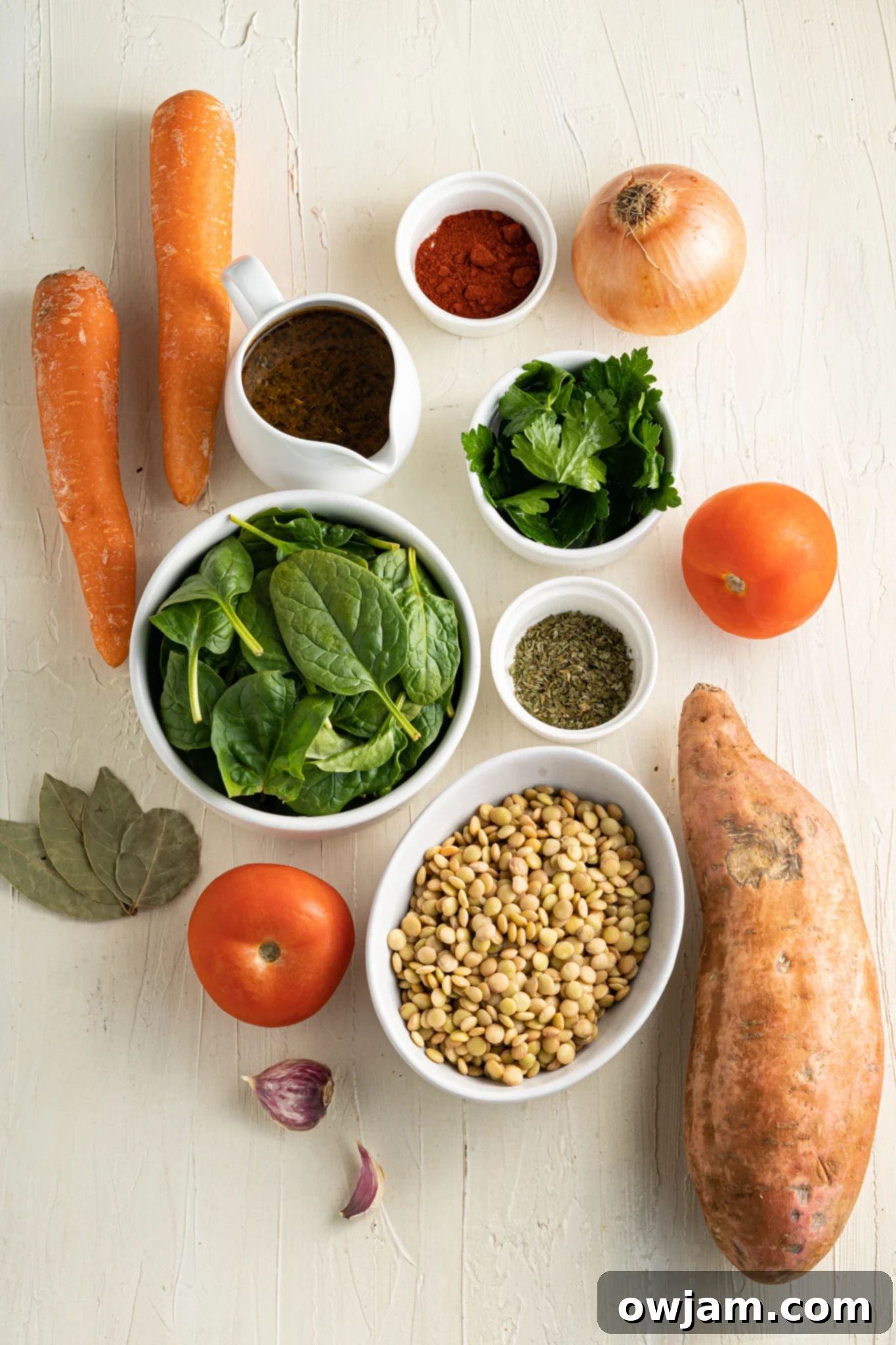 Nourishing Sweet Potato and Lentil Soup 3 Fresh, wholesome ingredients for Sweet Potato Lentil Soup, including sweet potatoes, lentils, carrots, celery, and spinach.
