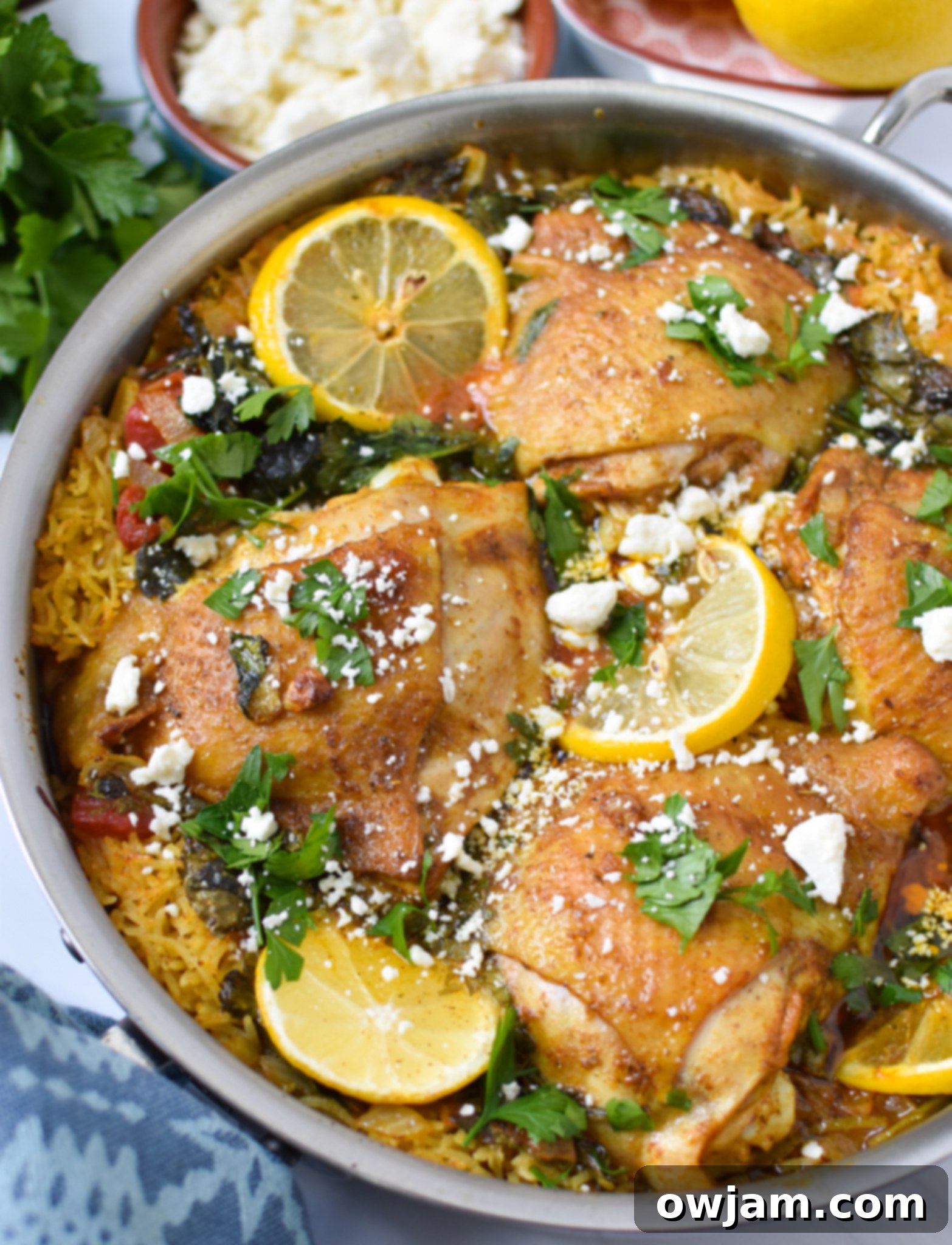 One Pot Mediterranean Chicken and Rice ready to serve with feta cheese and fresh herbs.