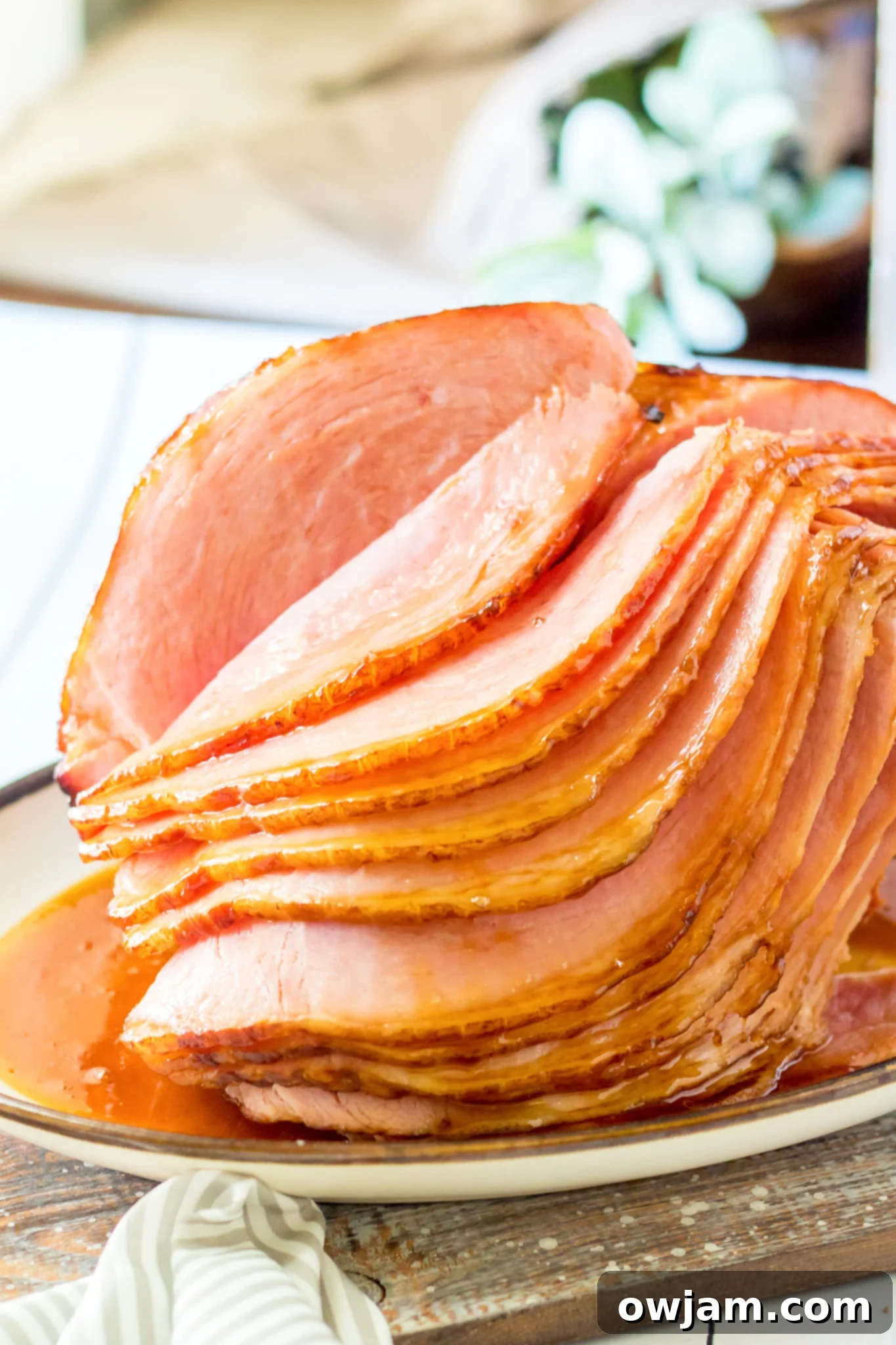 Juicy Apple Cider Glazed Ham Recipe 2 Beautifully glazed spiral ham on a platter, ready to be served for a holiday meal.