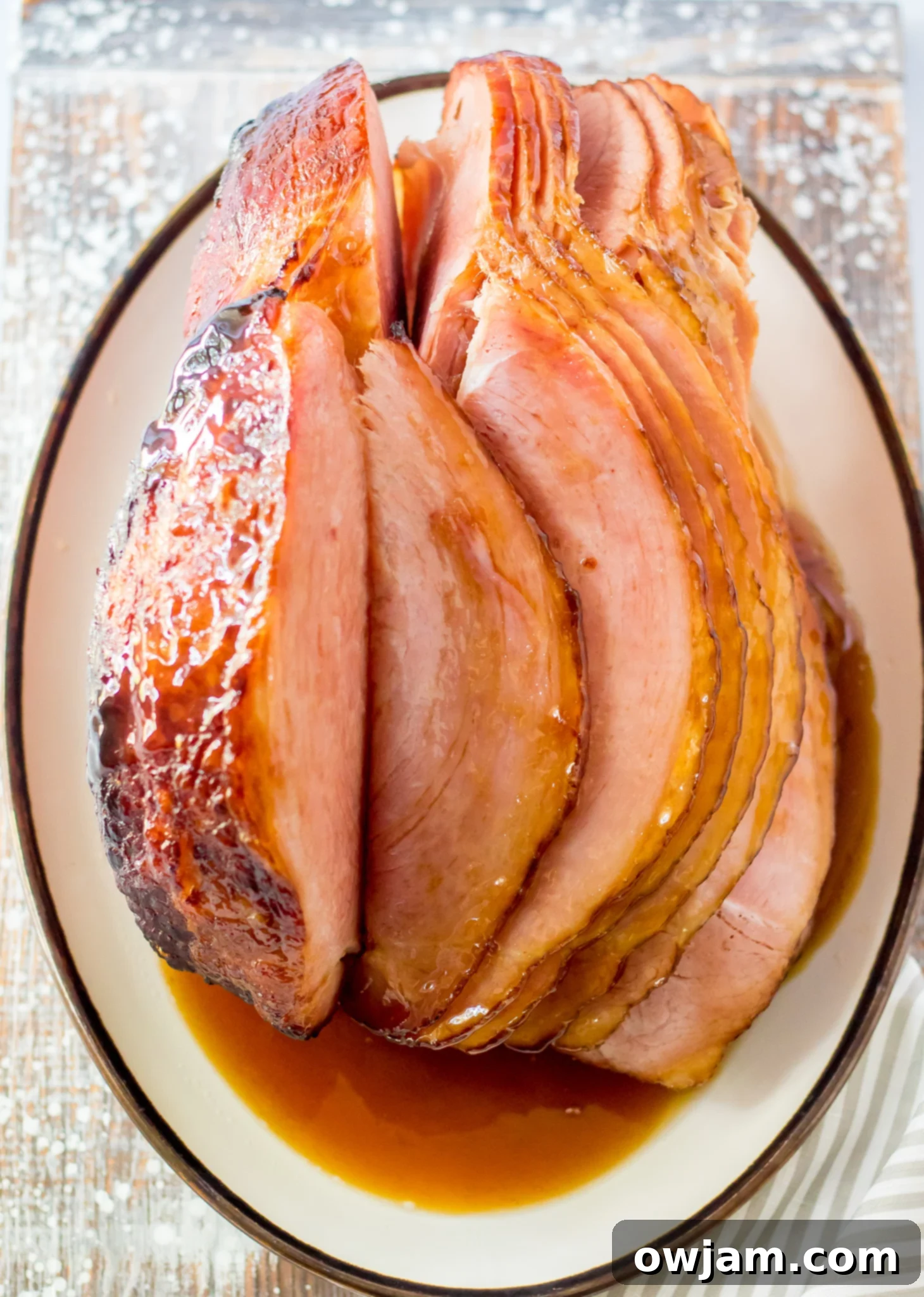 Juicy Apple Cider Glazed Ham Recipe 8 Apple Cider Glazed Ham in a roasting dish, glistening with the sweet glaze.