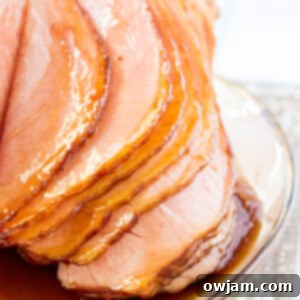 Juicy Apple Cider Glazed Ham Recipe 10 Apple Cider Glazed Ham Recipe sliced on platter.