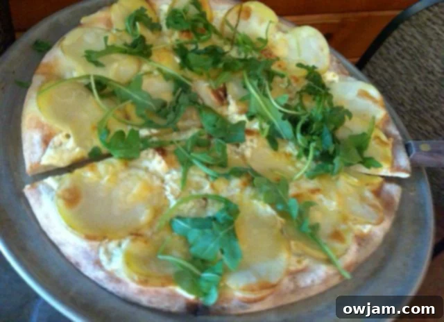 Delicious potato pizza with raclette cheese and arugula