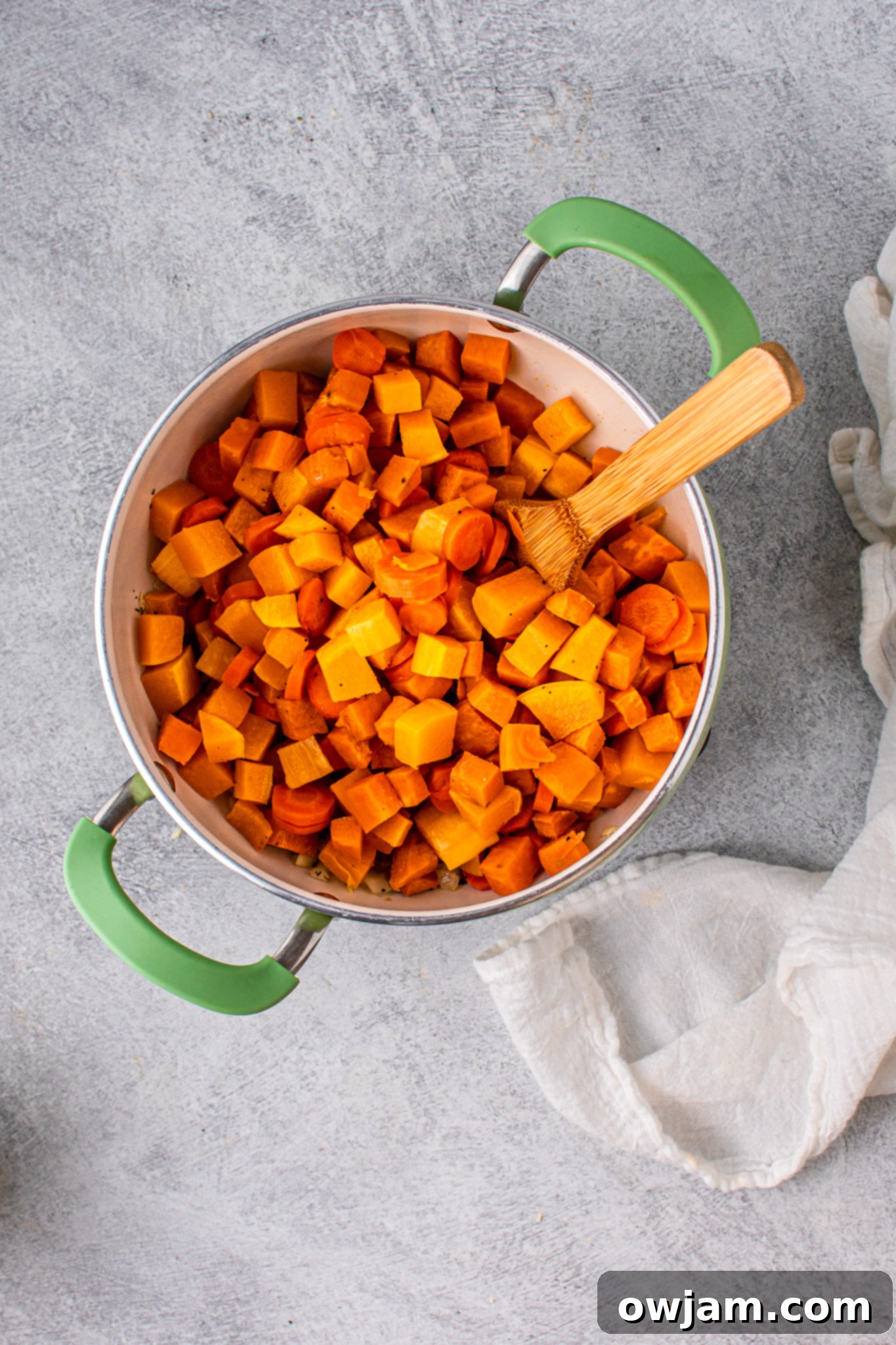 Golden Butternut Sweet Potato Comfort 7 Soup ingredients simmering in a pot.