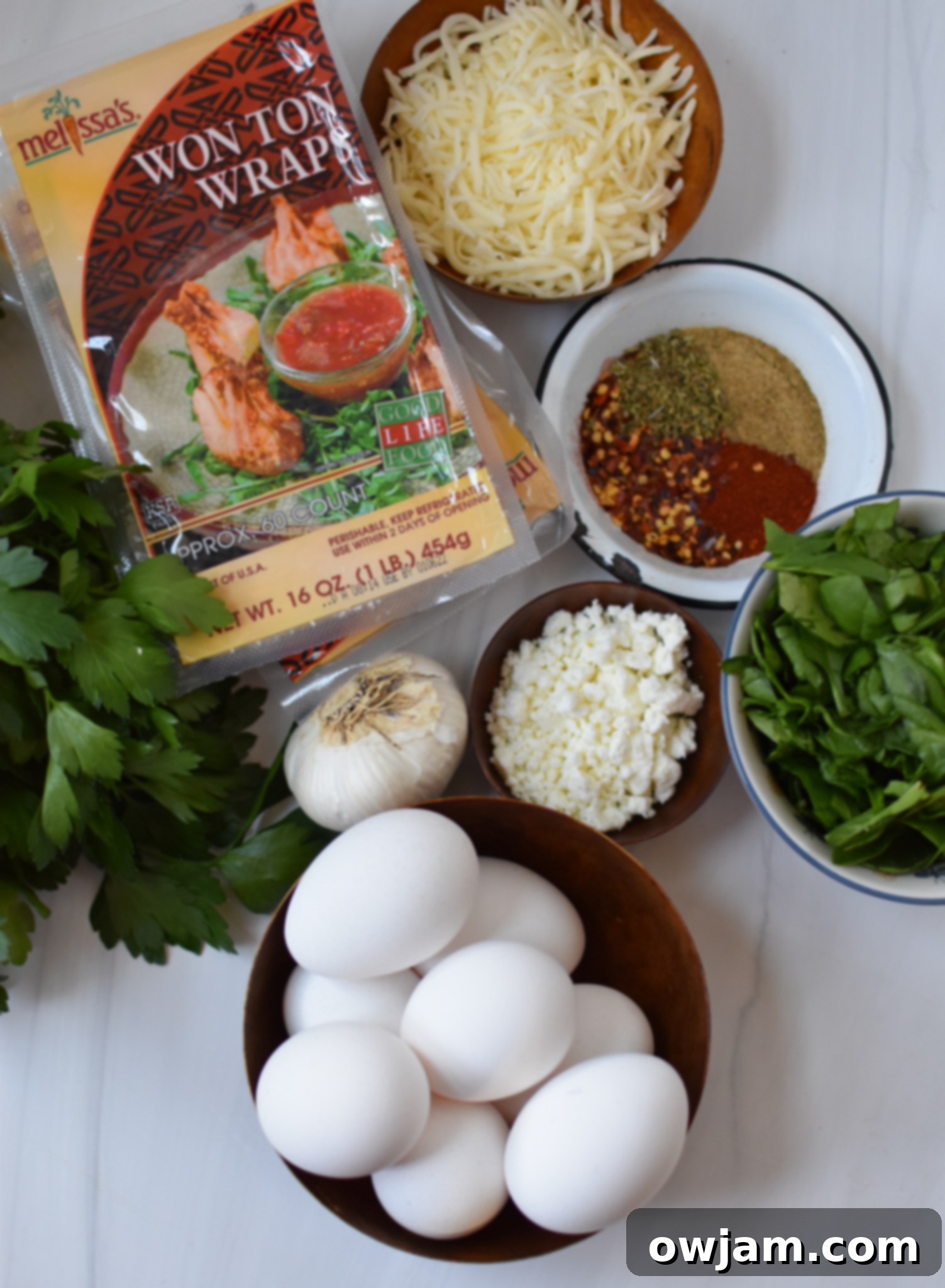 Crispy Mediterranean Feta Parcels 3 Assortment of Mediterranean Quiche Wontons ingredients laid out.