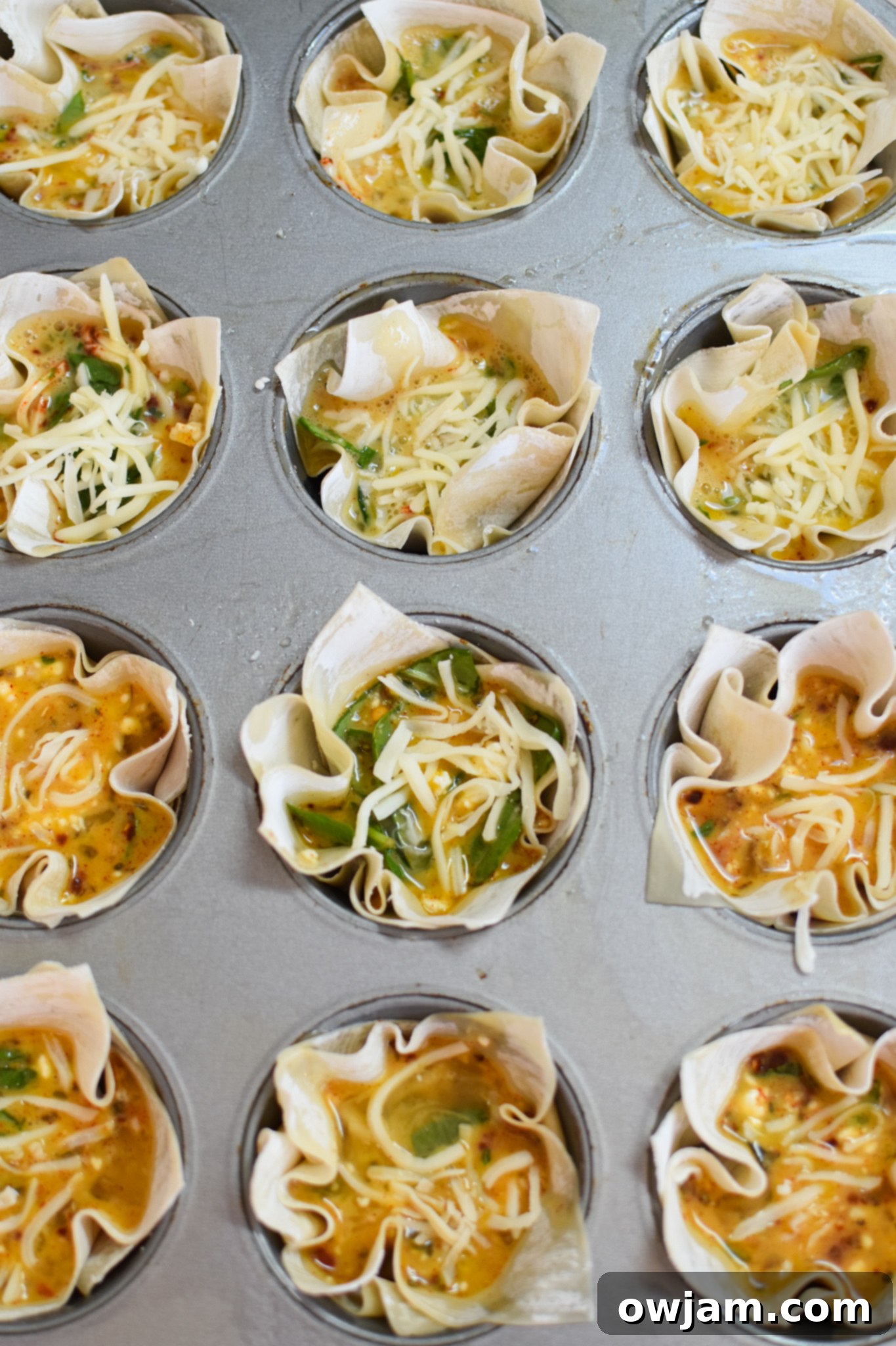 Crispy Mediterranean Feta Parcels 7 Mediterranean Quiche Wontons in the muffin tin, filled and ready to bake.