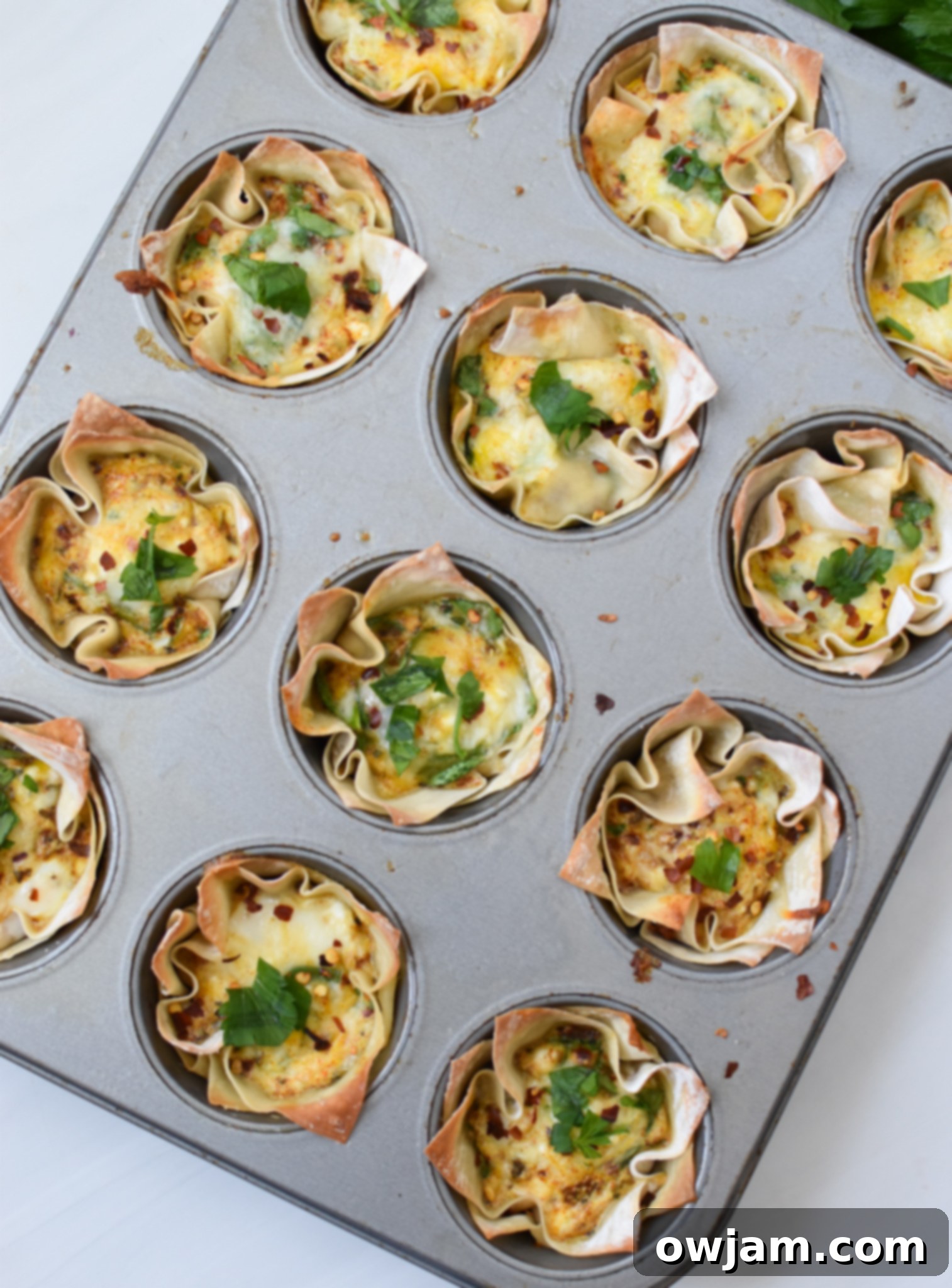 Crispy Mediterranean Feta Parcels 8 Baked Mediterranean Quiche Wontons in muffin tins.